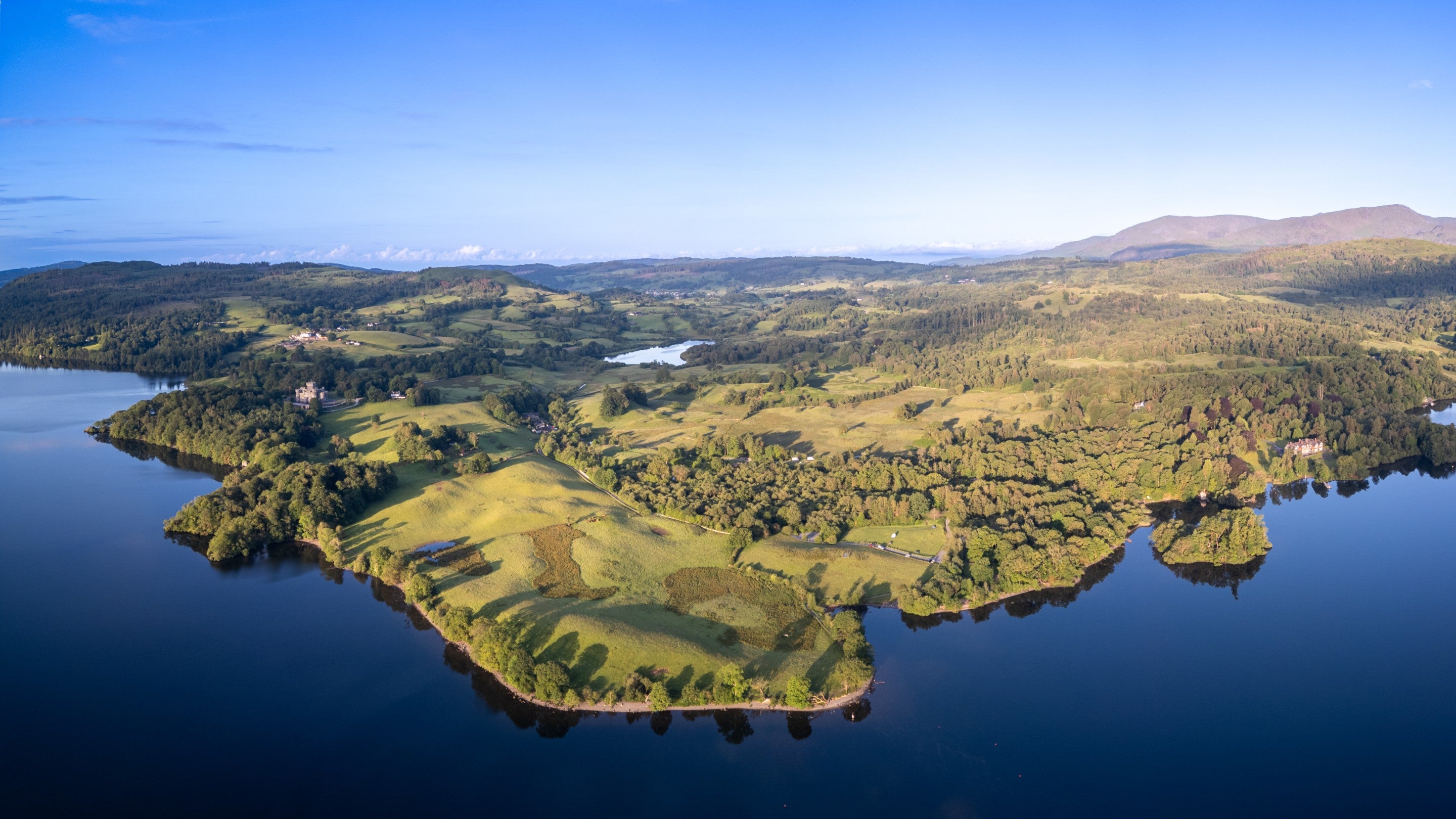 An aerial view of Lake Windermere and the countryside around Wray Castle House, Cumbria