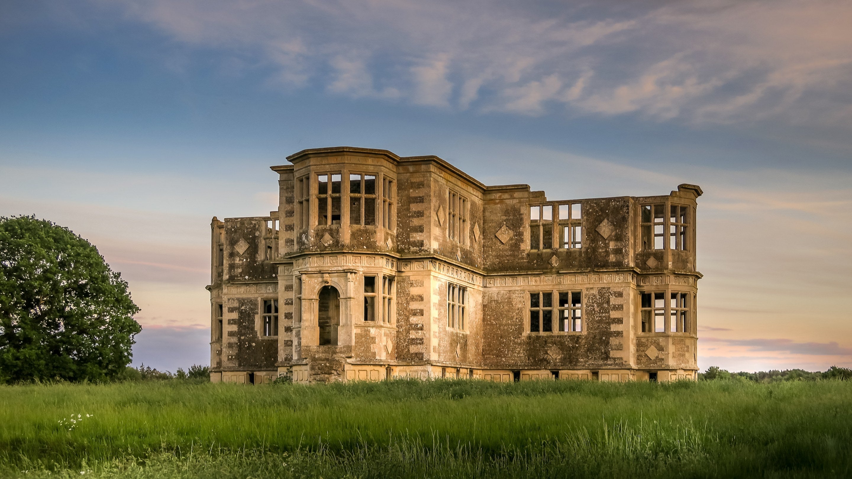 The unfinished Lyveden Garden Lodge, with walls, stone window frames, but without a roof, Northamptonshire