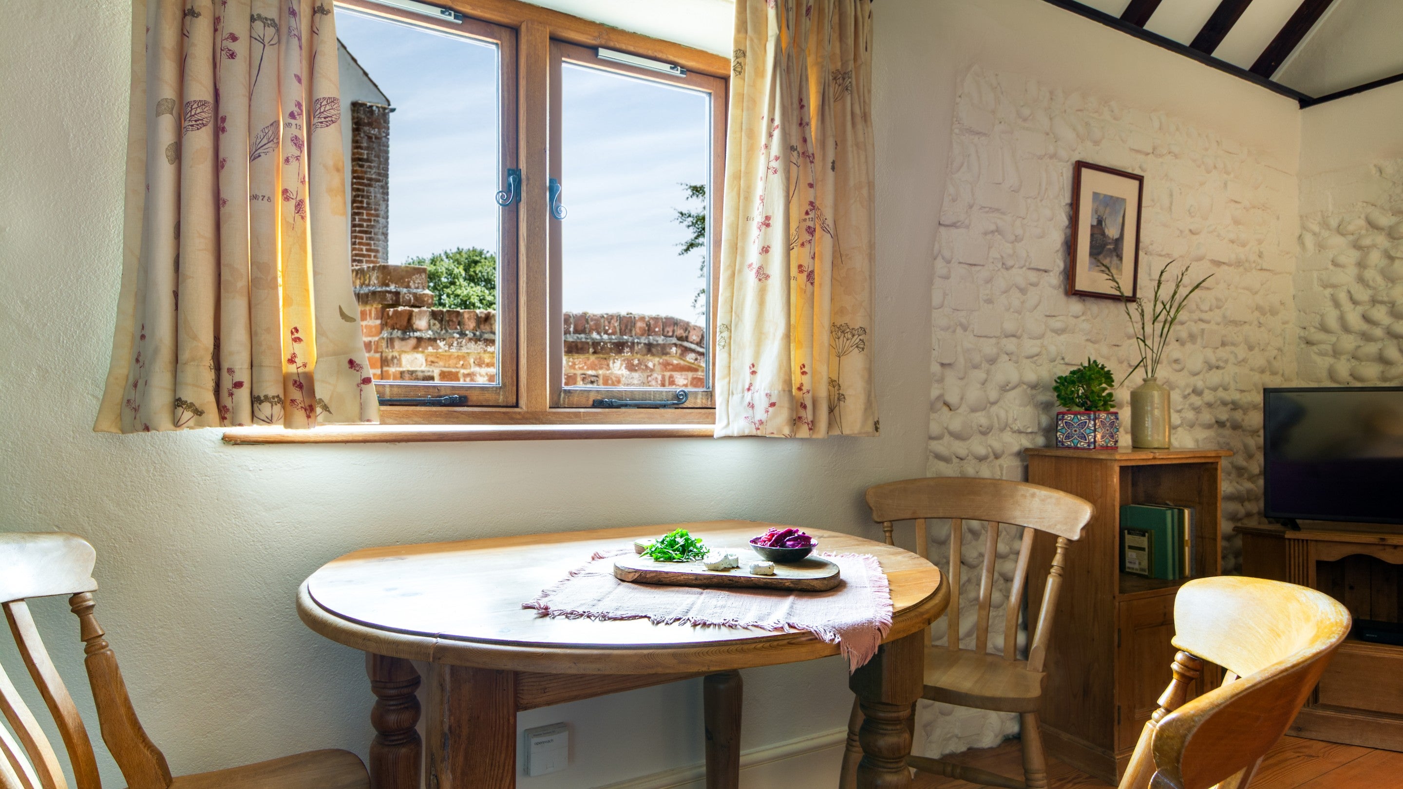 The dining table in the open-plan kitchen, dining and sitting room at 1 Horsey Barns, Norfolk