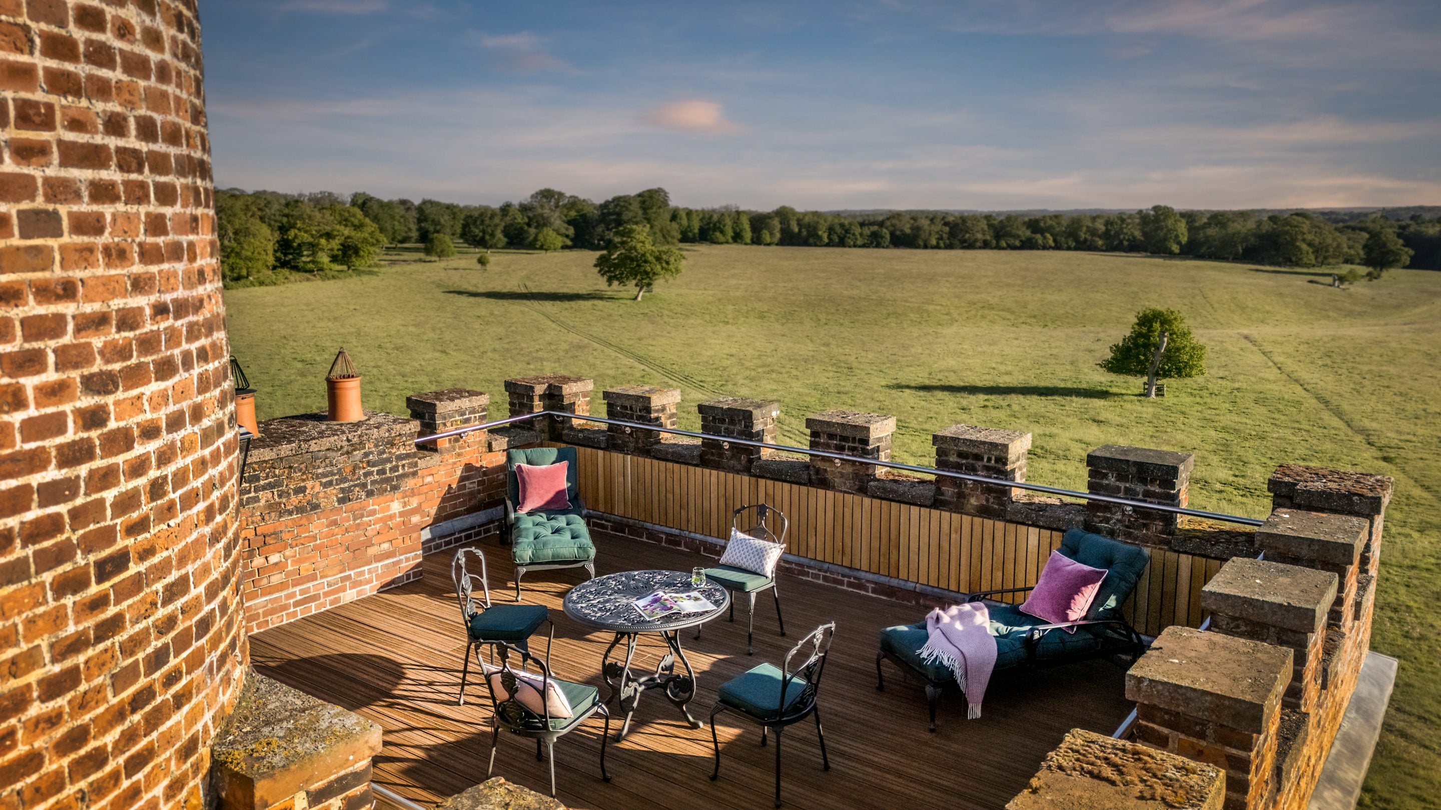 An aerial view of the roof terrace at Blickling Tower with a table, four chairs and two loungers, Norfolk