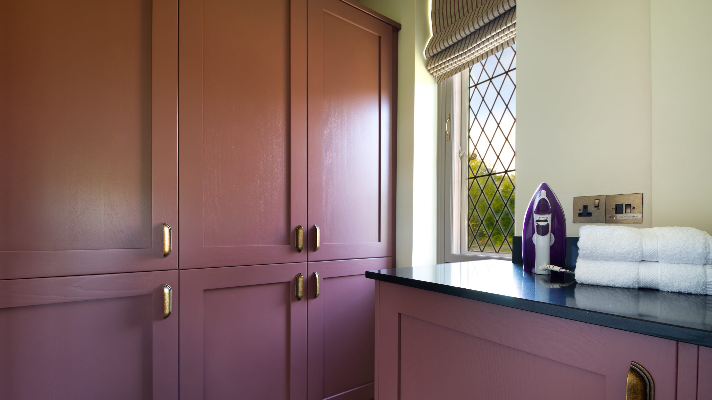 The utility room next to the kitchen with storage cupboards at Blickling Tower, Norfolk