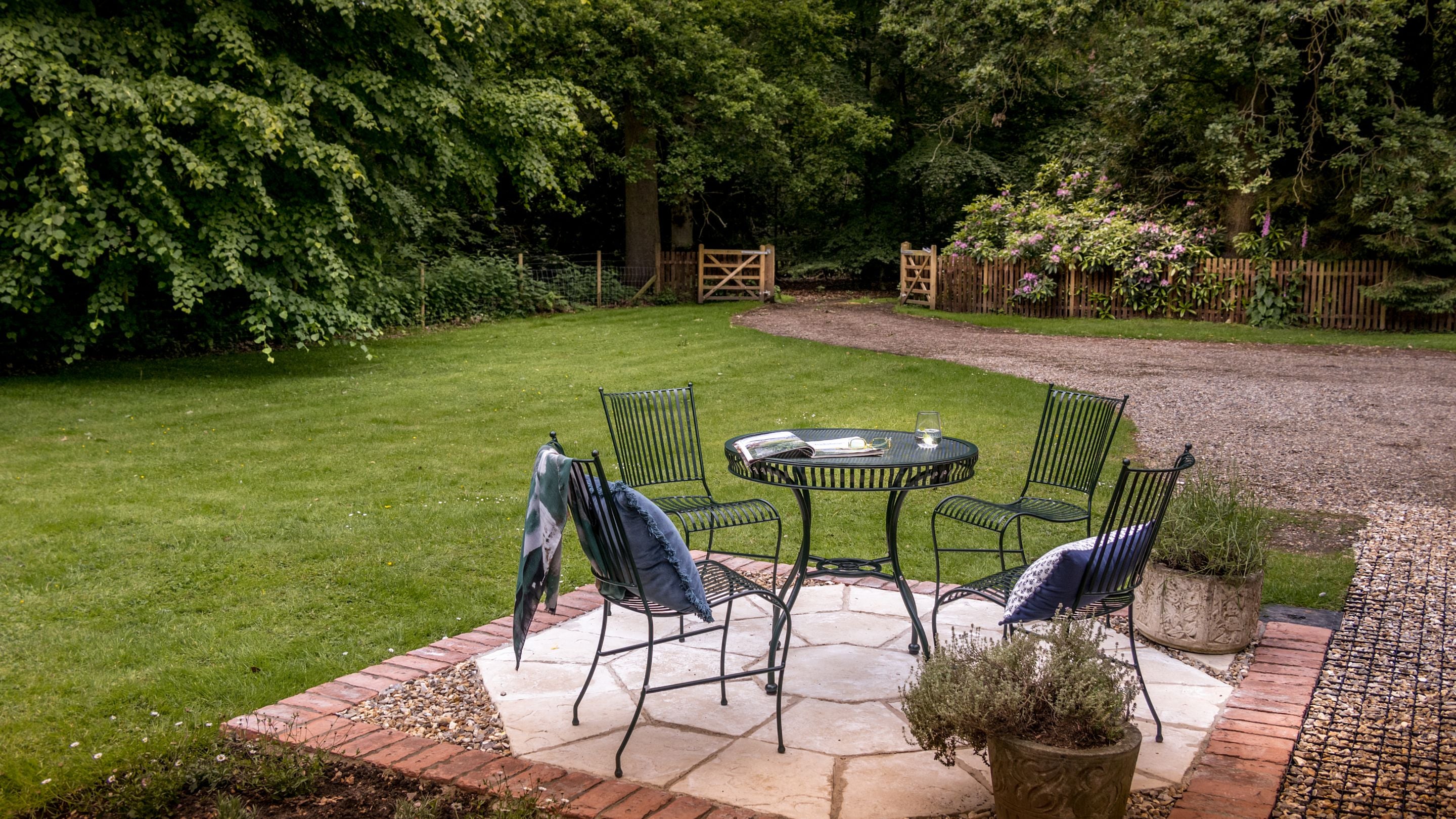 The patio in the garden of Mustard Pot Cottage, with outdoor dining furniture, Norfolk