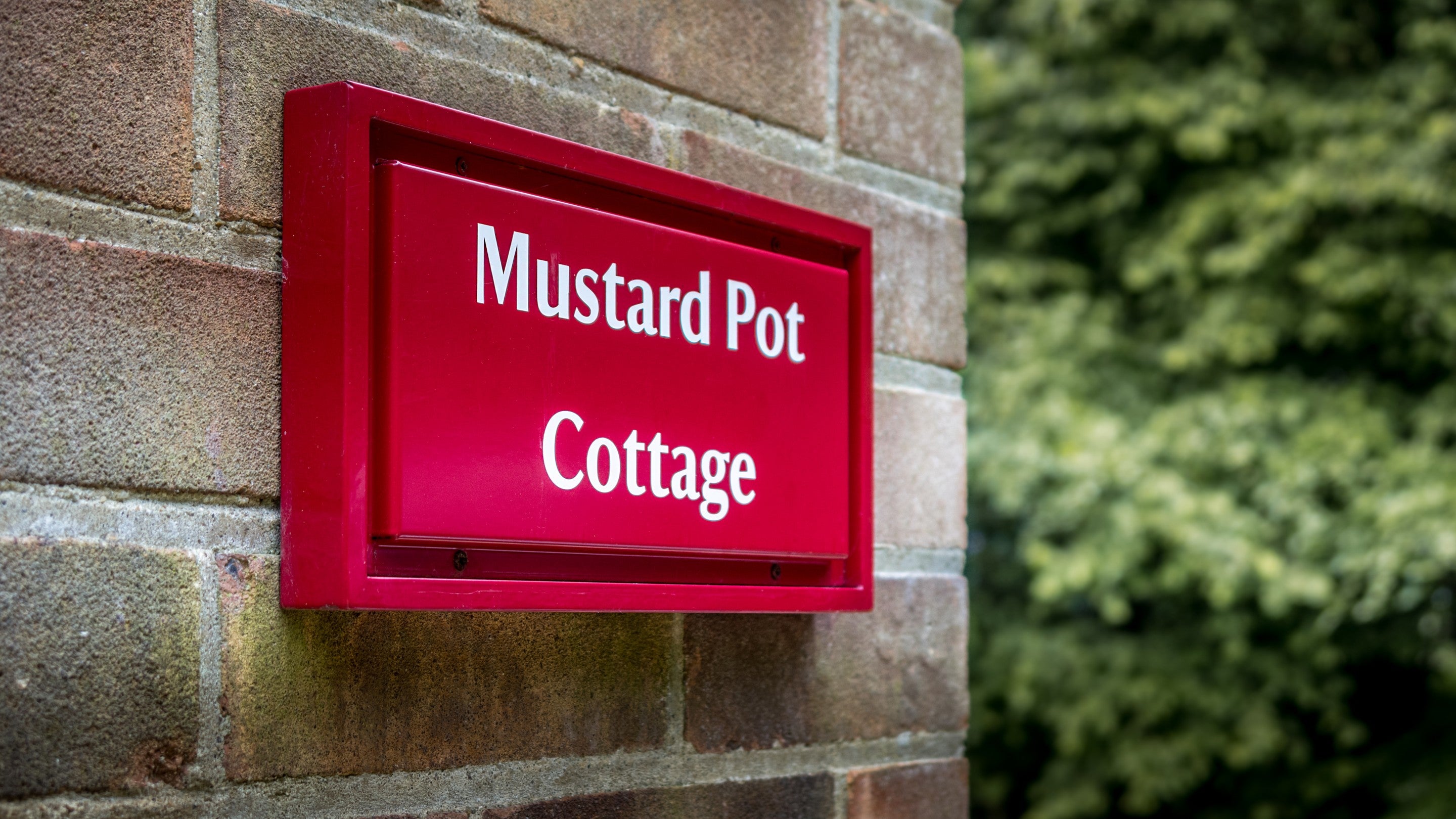 The sign for Mustard Pot Cottage, Norfolk