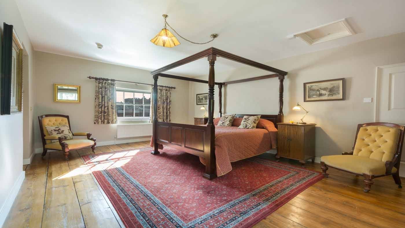 An oppulent four poster bed at The Squire's Retreat, Cromer, Norfolk
