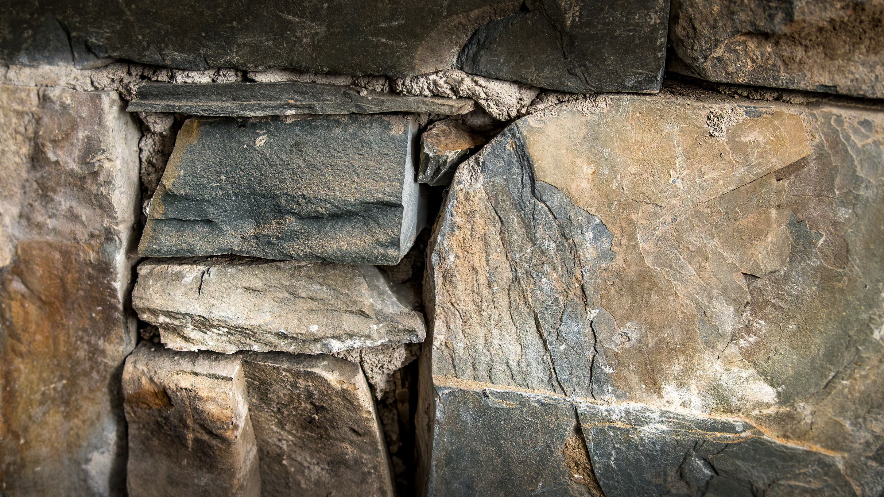 The original stone fireplace in the sitting room at Castle Ward Gamekeeper's Lodge, County Down