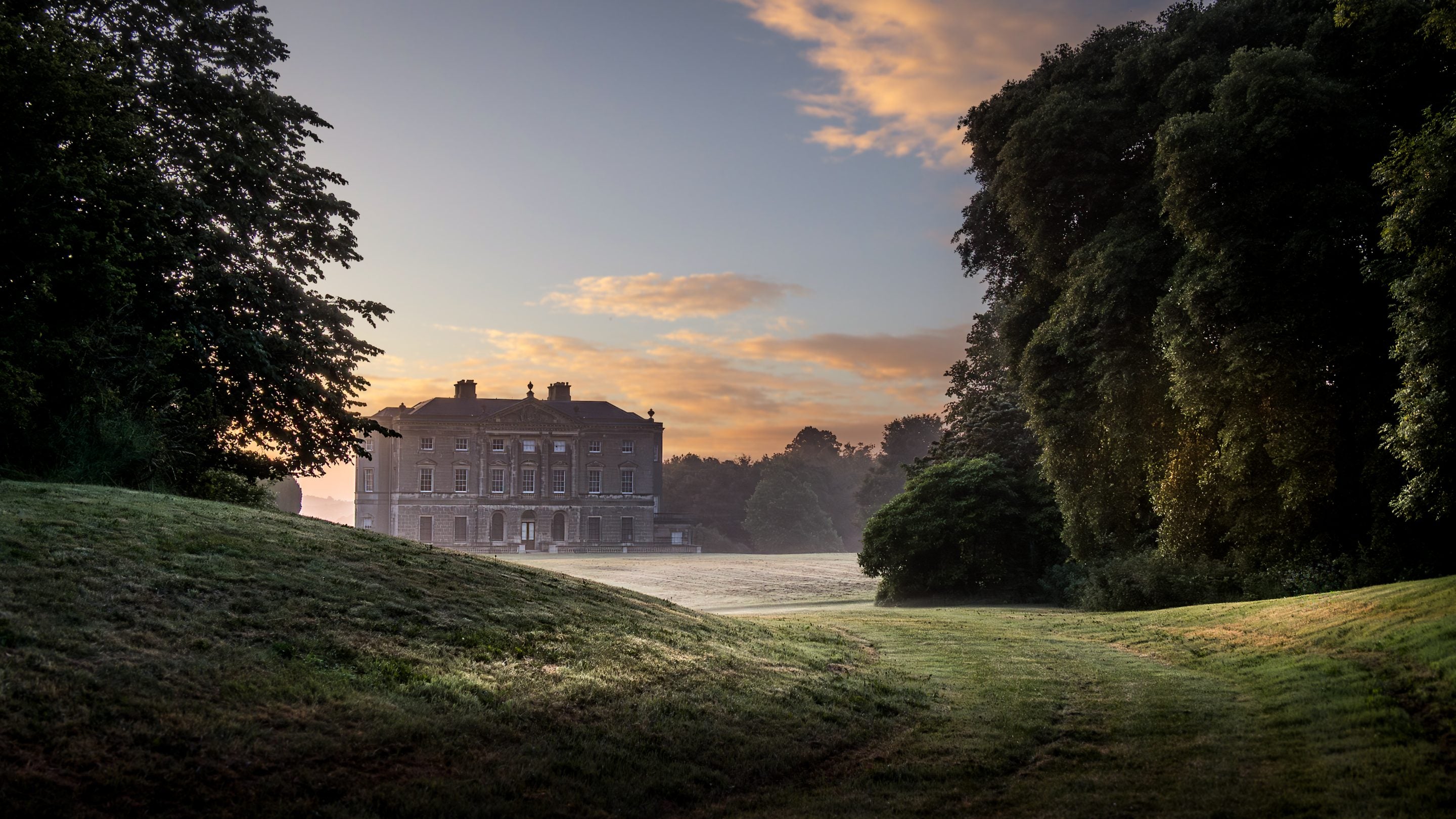 The mansion at Castle Ward at sunrise, with dew covering the grass outside, County Down