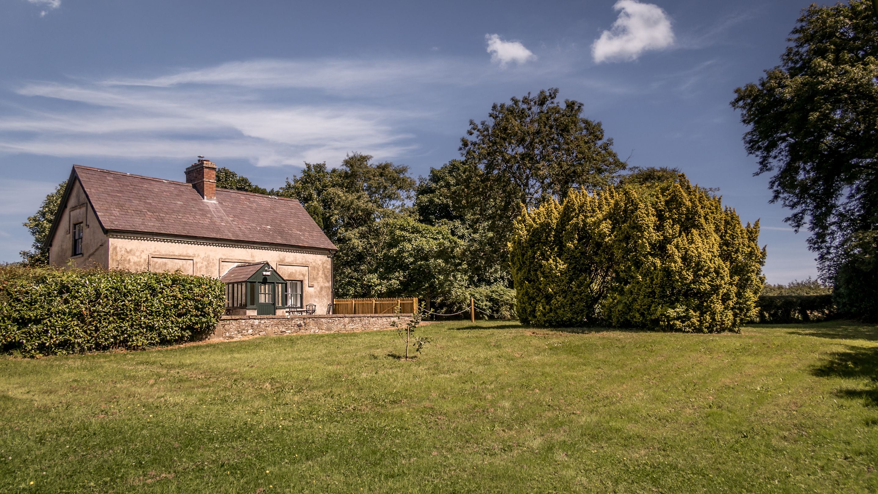 The garden at the front of Castle Ward Gamekeeper's Lodge, with large lawned area, County Down