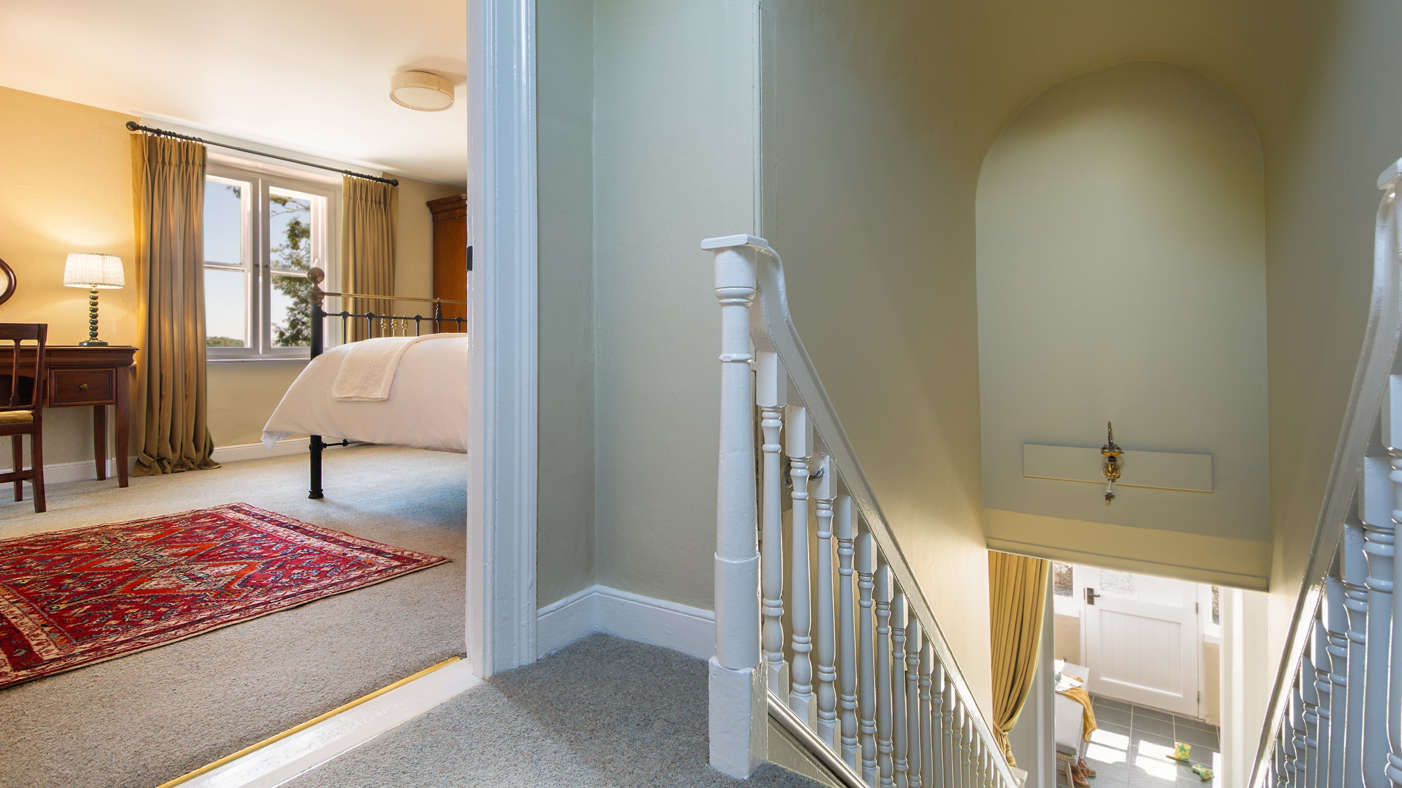 The stairs with a high, domed ceiling, leading to the first floor of Castle Ward Gamekeeper's Lodge, County Down