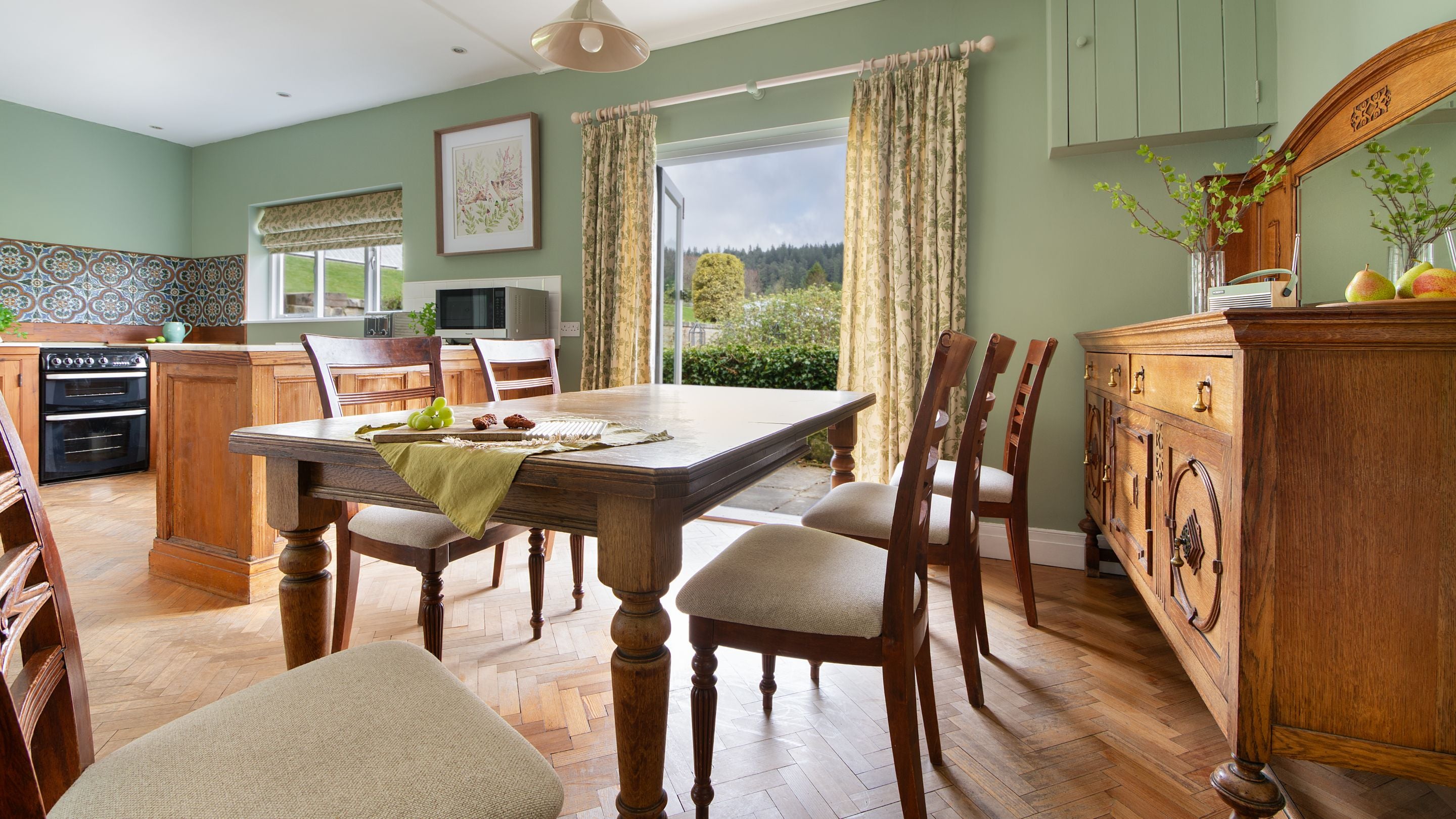 The kitchen and dining room at Cragside Garden Cottage, with glass doors onto a private terrace, Northumberland