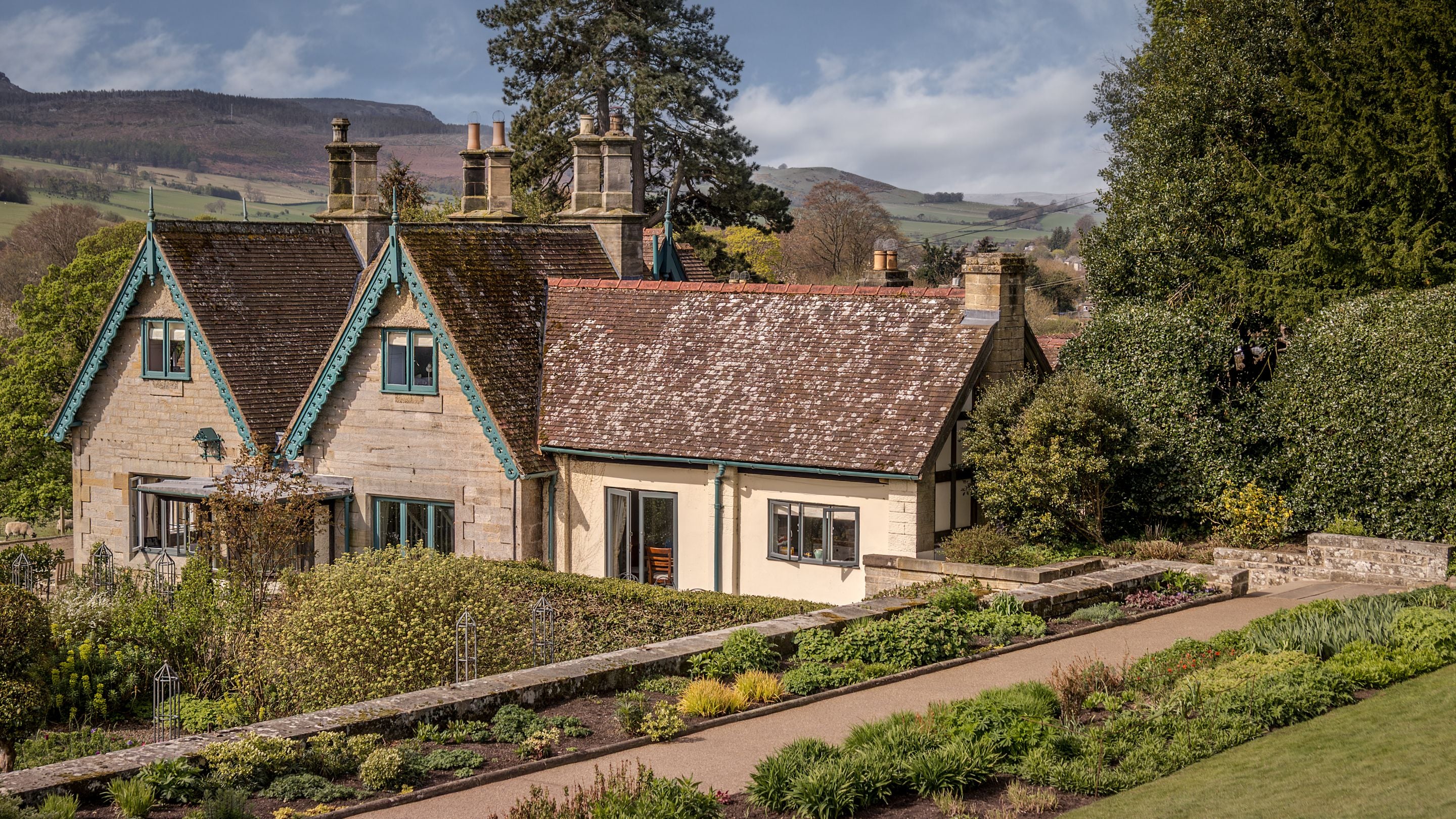 The formal gardens at Cragside with Cragside Garden Cottage behind, Northumberland