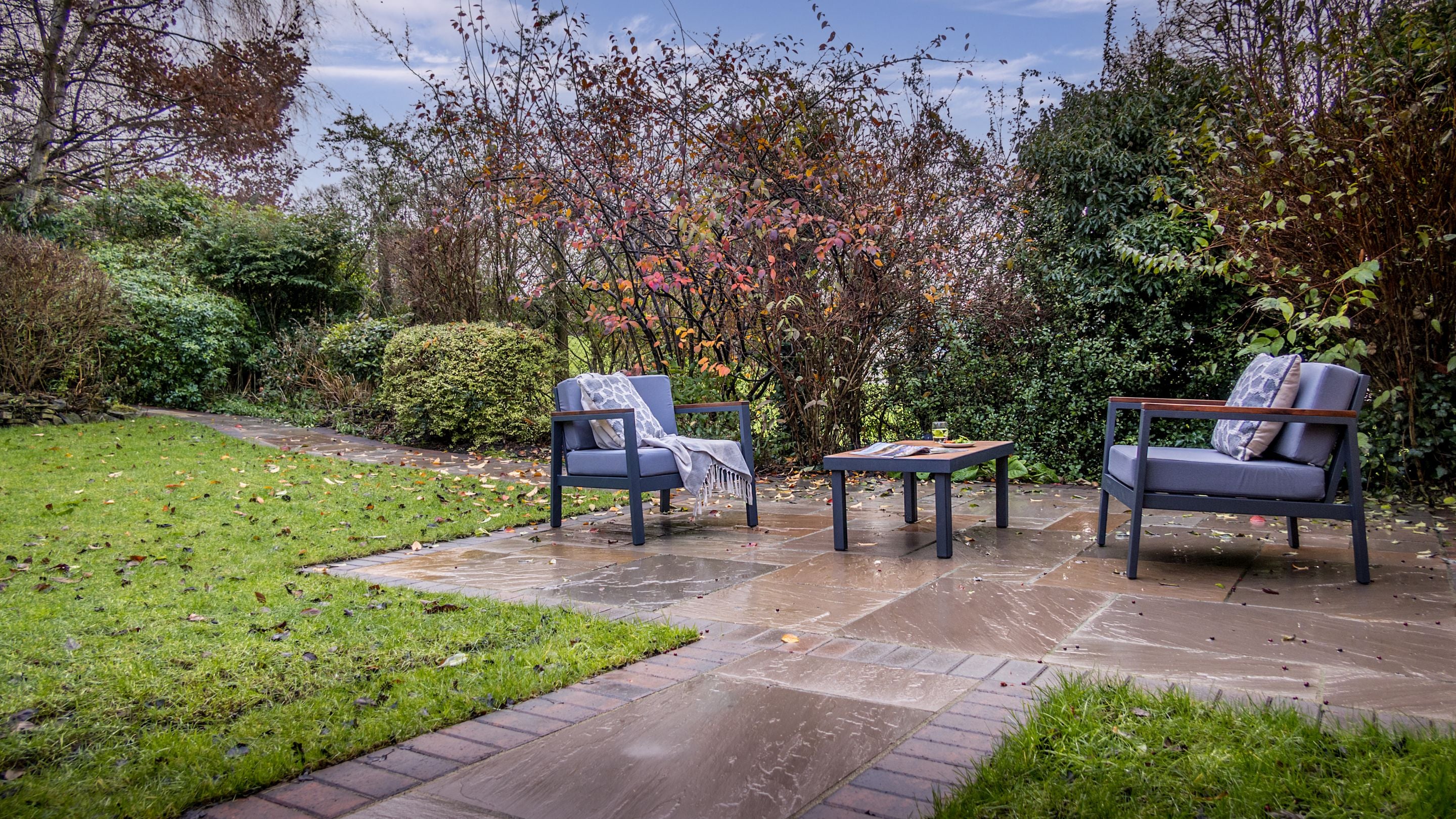 The private garden, with lawn, patio and outdoor furniture, for guests staying at Garden Gate Apartment, Durham
