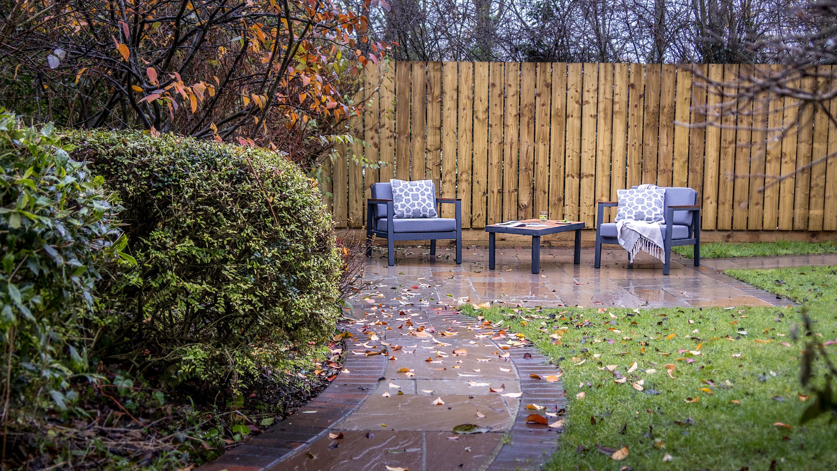 The private garden, with lawn, patio and outdoor furniture, for guests staying at Garden Gate Apartment, Durham