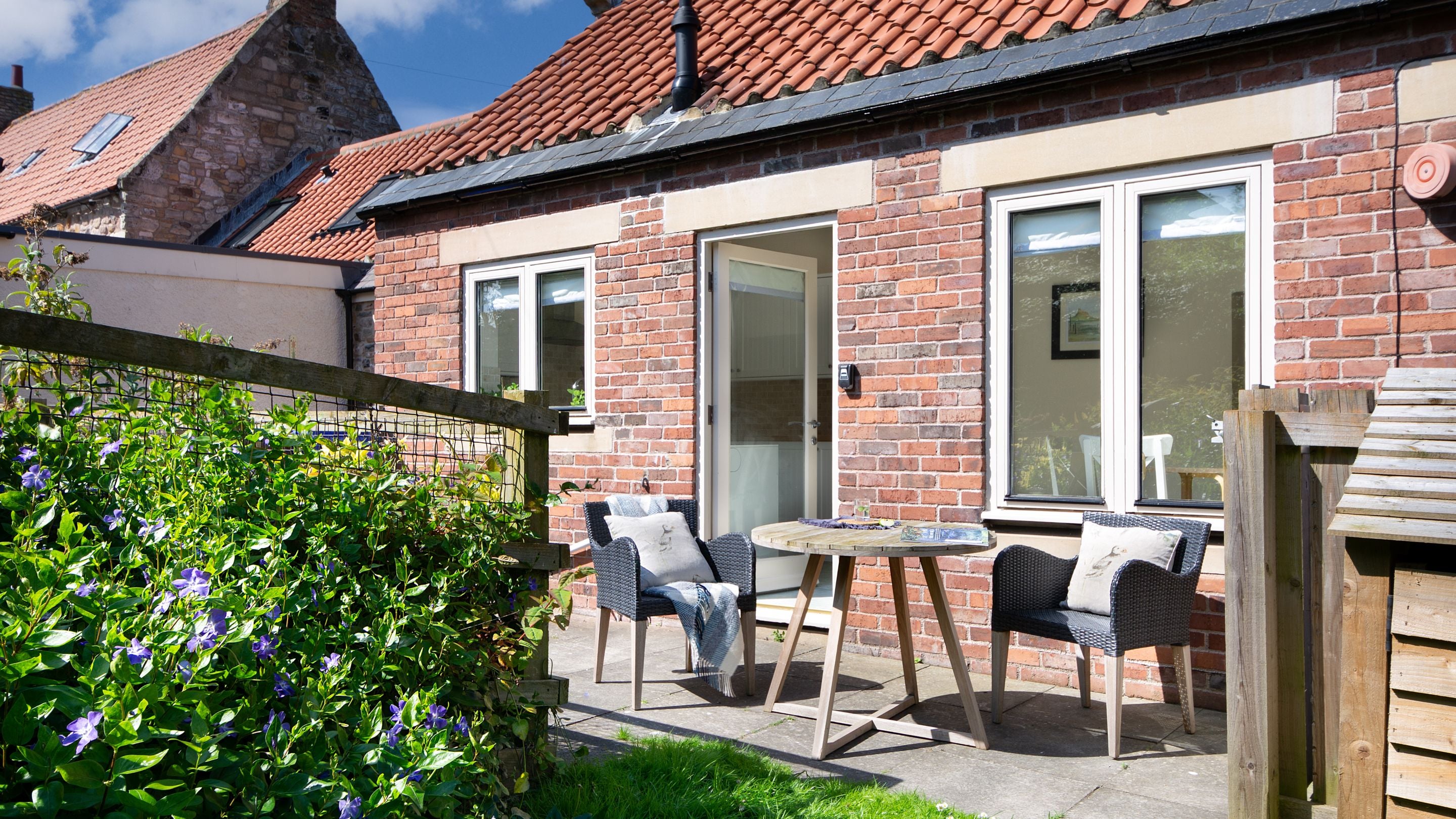 The garden at the rear of Glen House with table and chairs on the patio, Northumberland