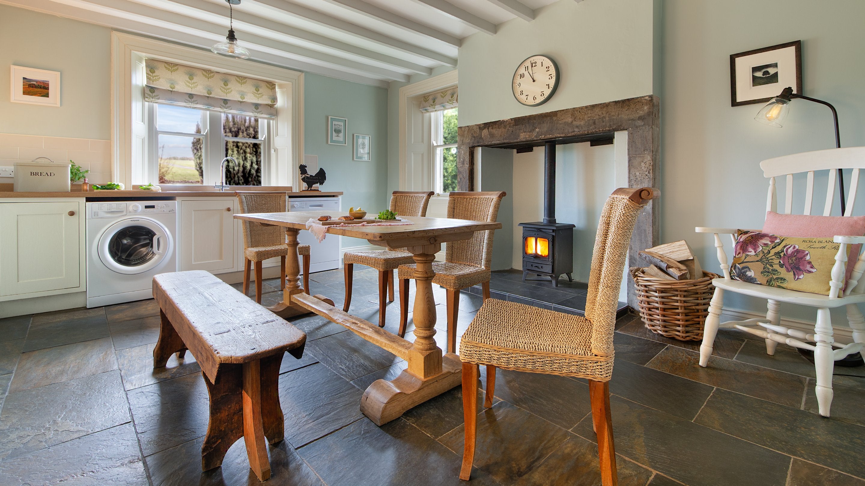 The open-plan kitchen and dining room with inglenook and multi-fuel stove at Housesteads, Northumberland
