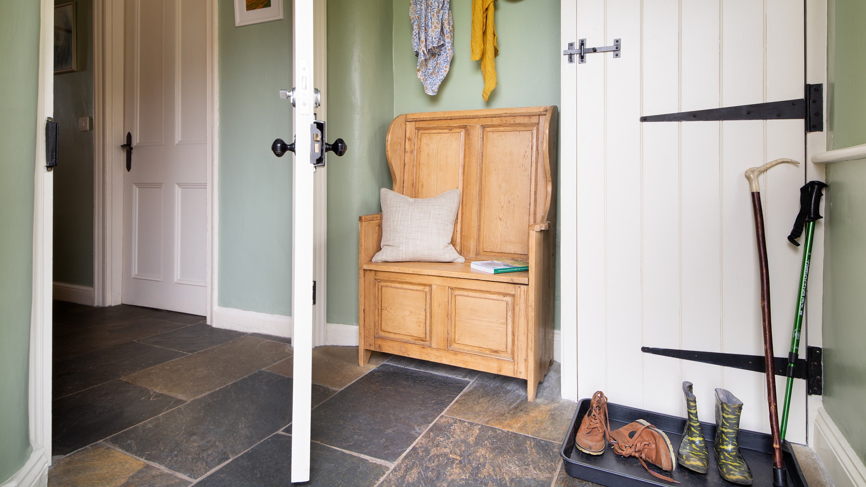 The porch at Housesteads, with wooden bench and coat hooks, Northumberland