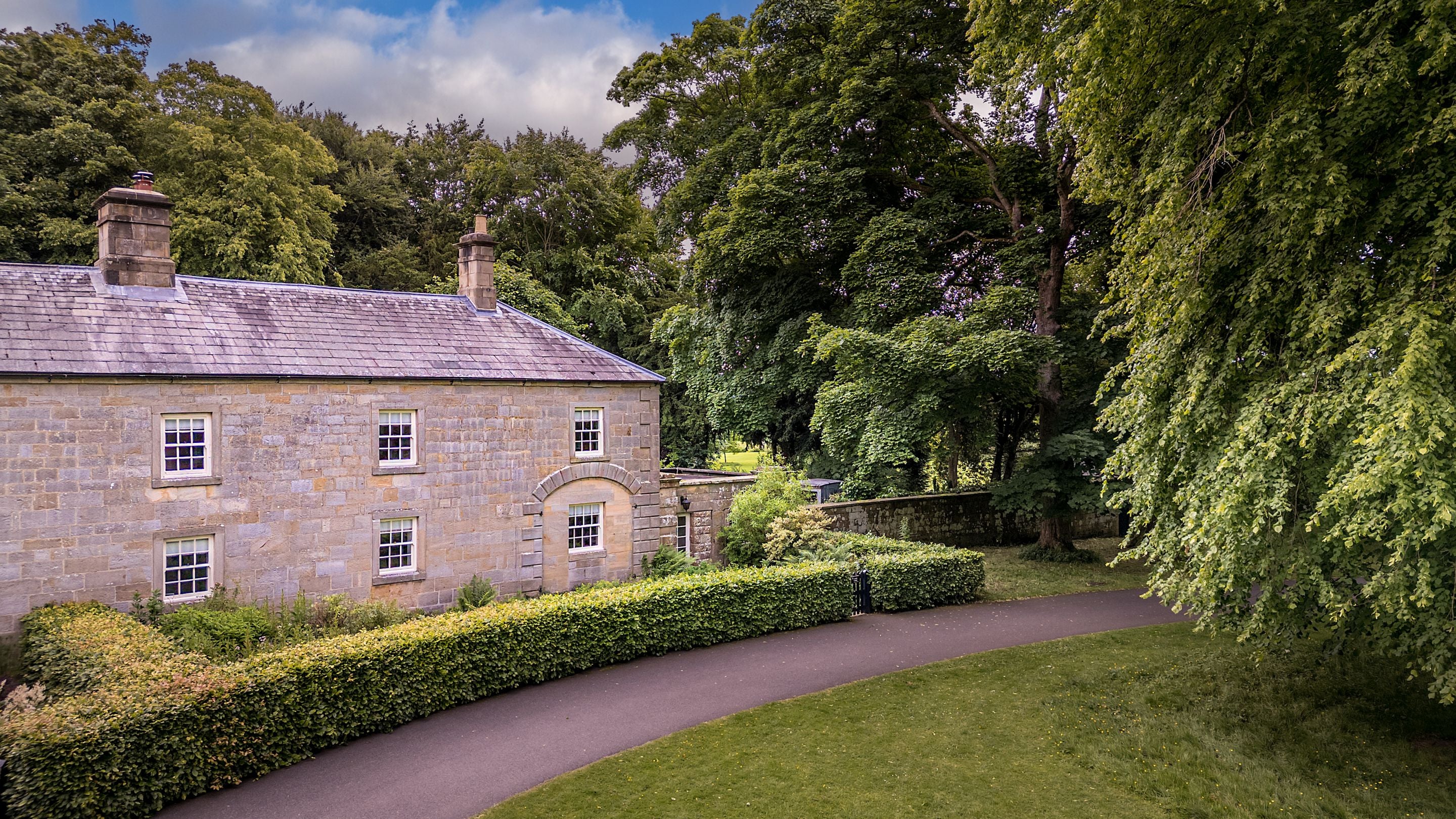 The exterior of Laundry Cottage, at the end of a row of cottages in the courtyard of Wallington, Northumberland