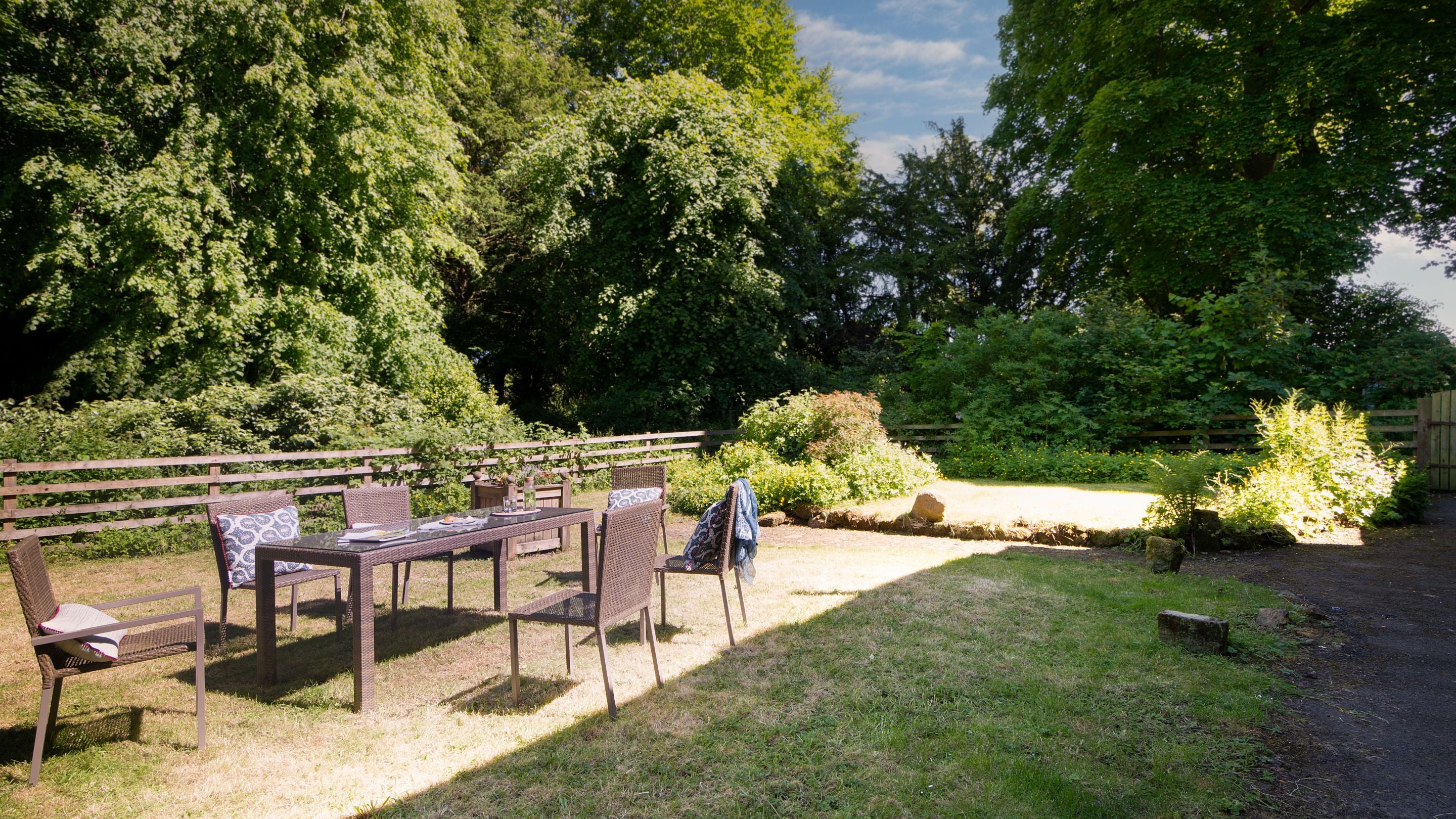 The lawned garden with dining furniture for six at Laundry Cottage, Northumberland