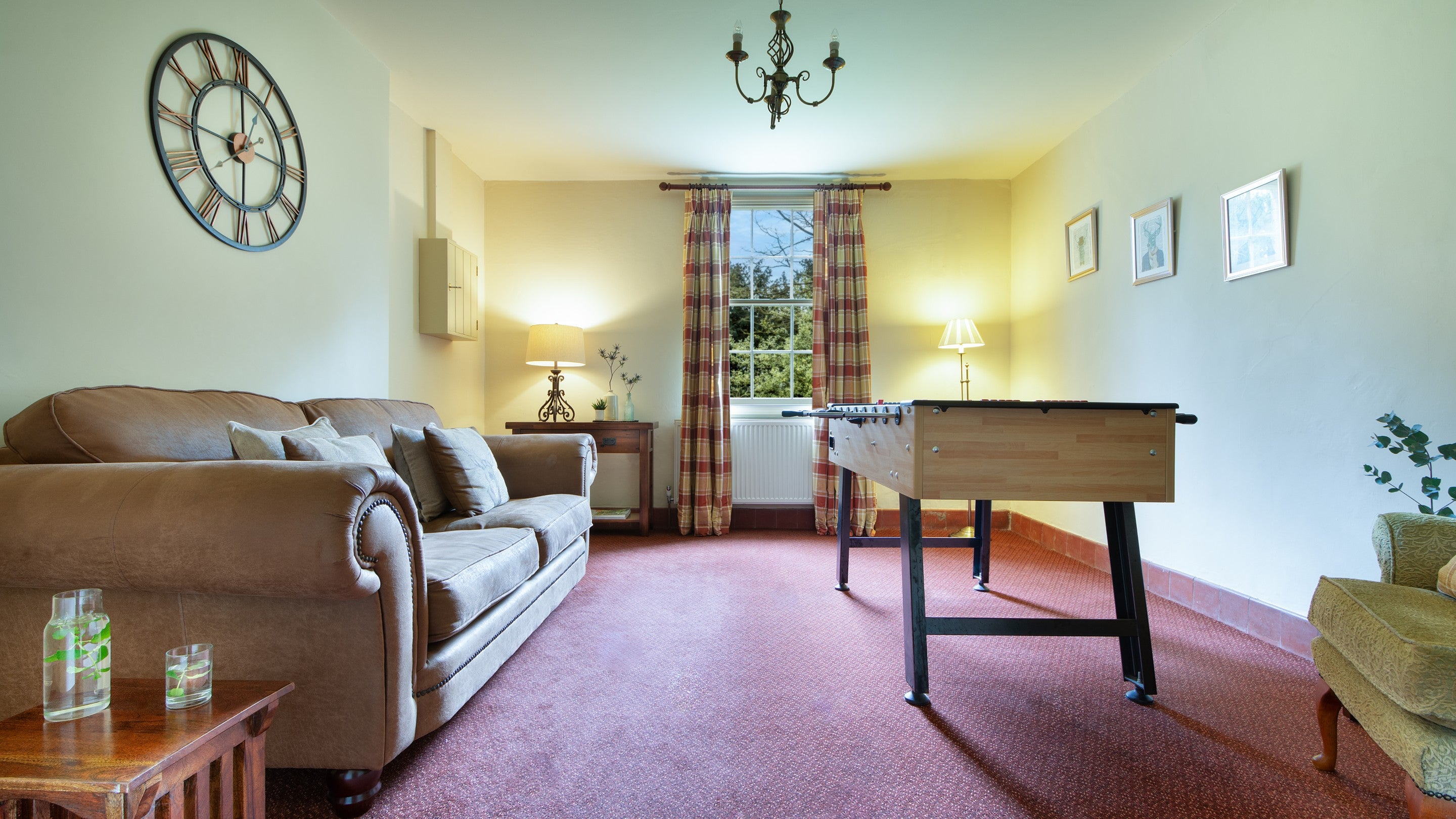 The games room with sofa and table football at Gunby Old Rectory, Lincolnshire