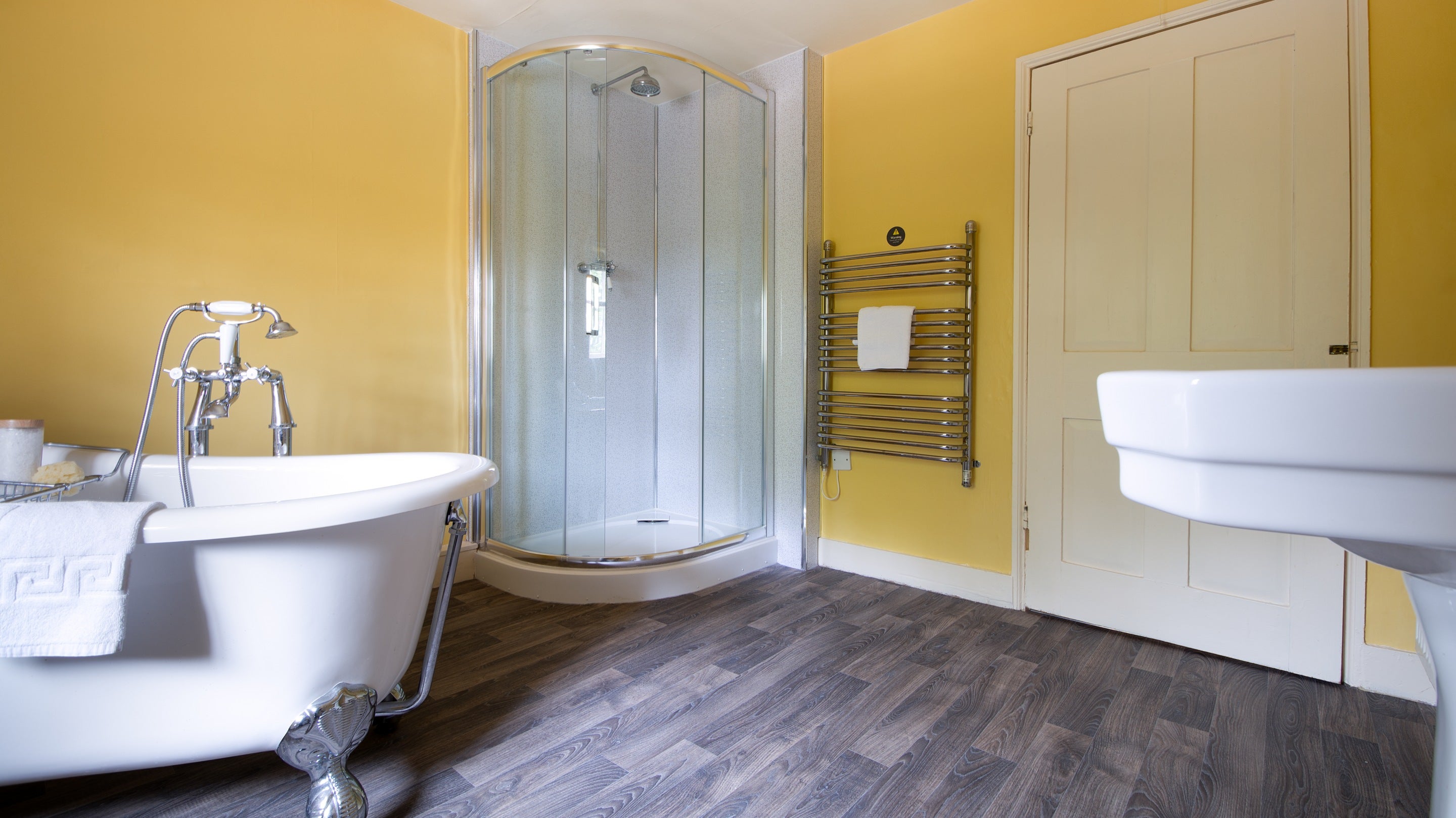 The second bathroom with roll-top bath and freestanding shower at Gunby Old Rectory, Lincolnshire