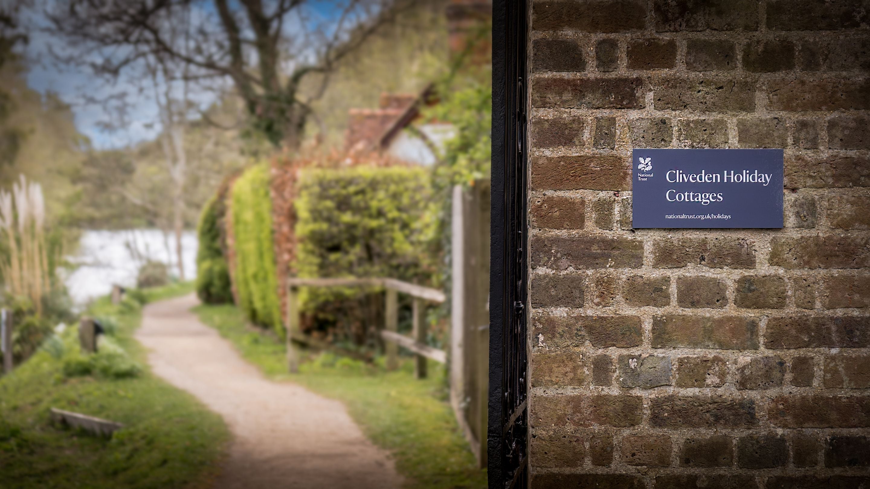 The sign by the riverside path to the holiday cottages at Cliveden, Berkshire