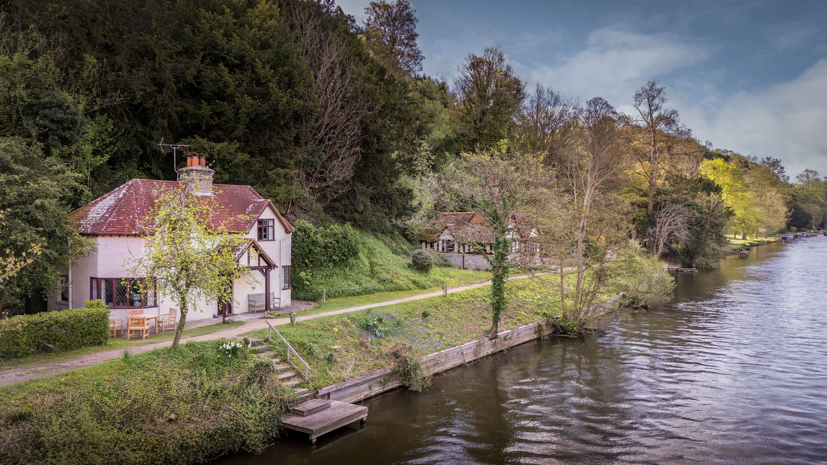 An aerial view of Cliveden New Cottage and Cliveden Ferry Cottage, on the banks of the River Thames, Berkshire