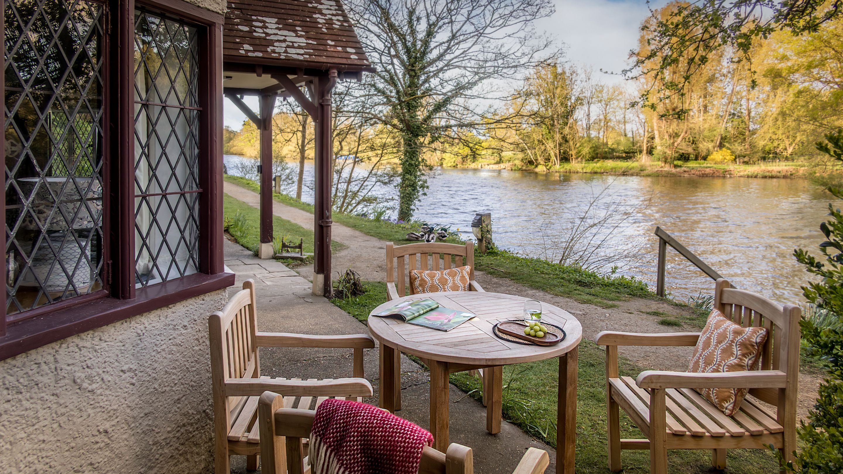 The outdoor dining furniture at the front of Cliveden New Cottage, overlooking the River Thames, Berkshire