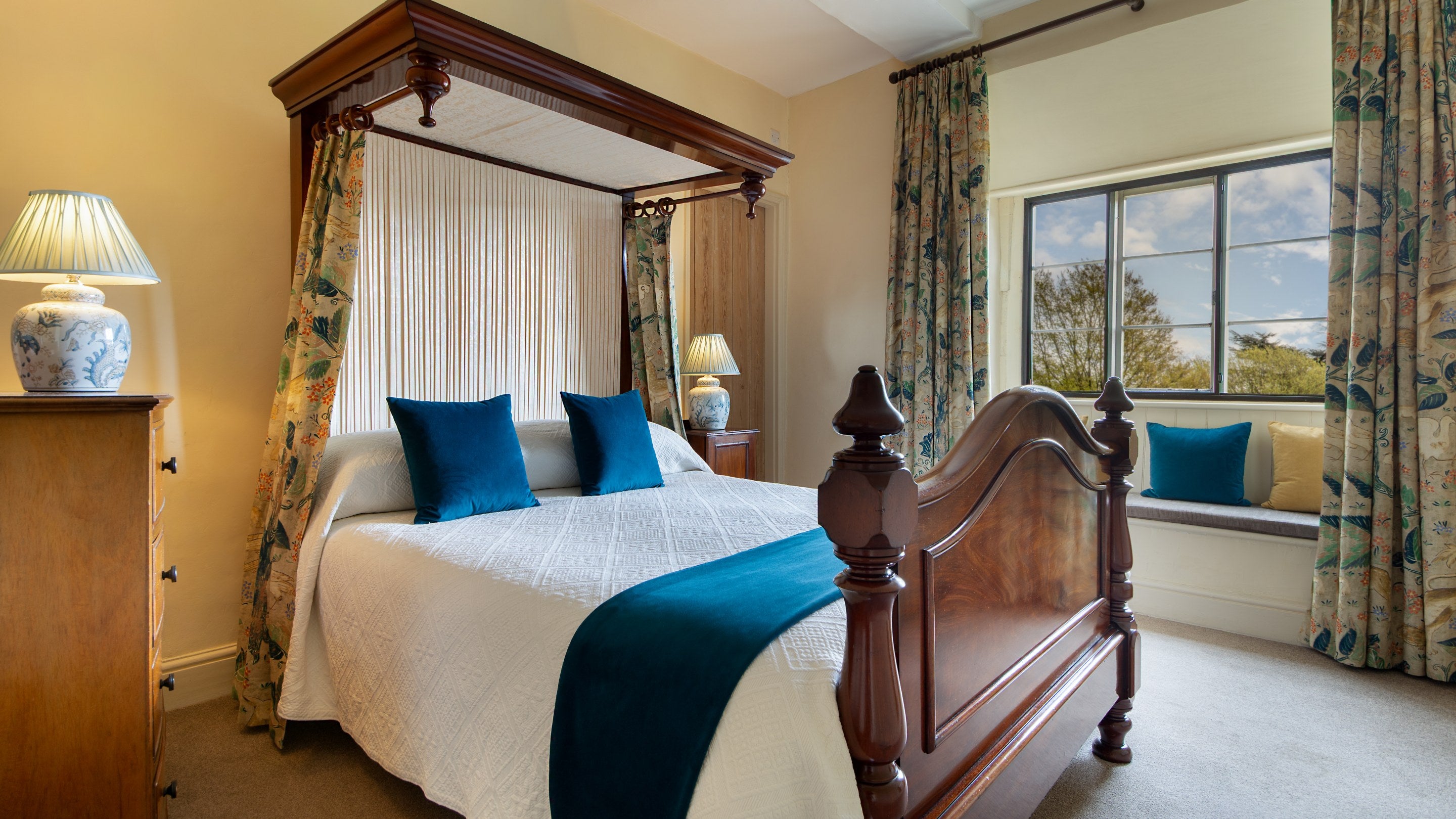 The double bedroom with antique mahogany half tester bed at 4 Stable Yard Cottage, Derbyshire