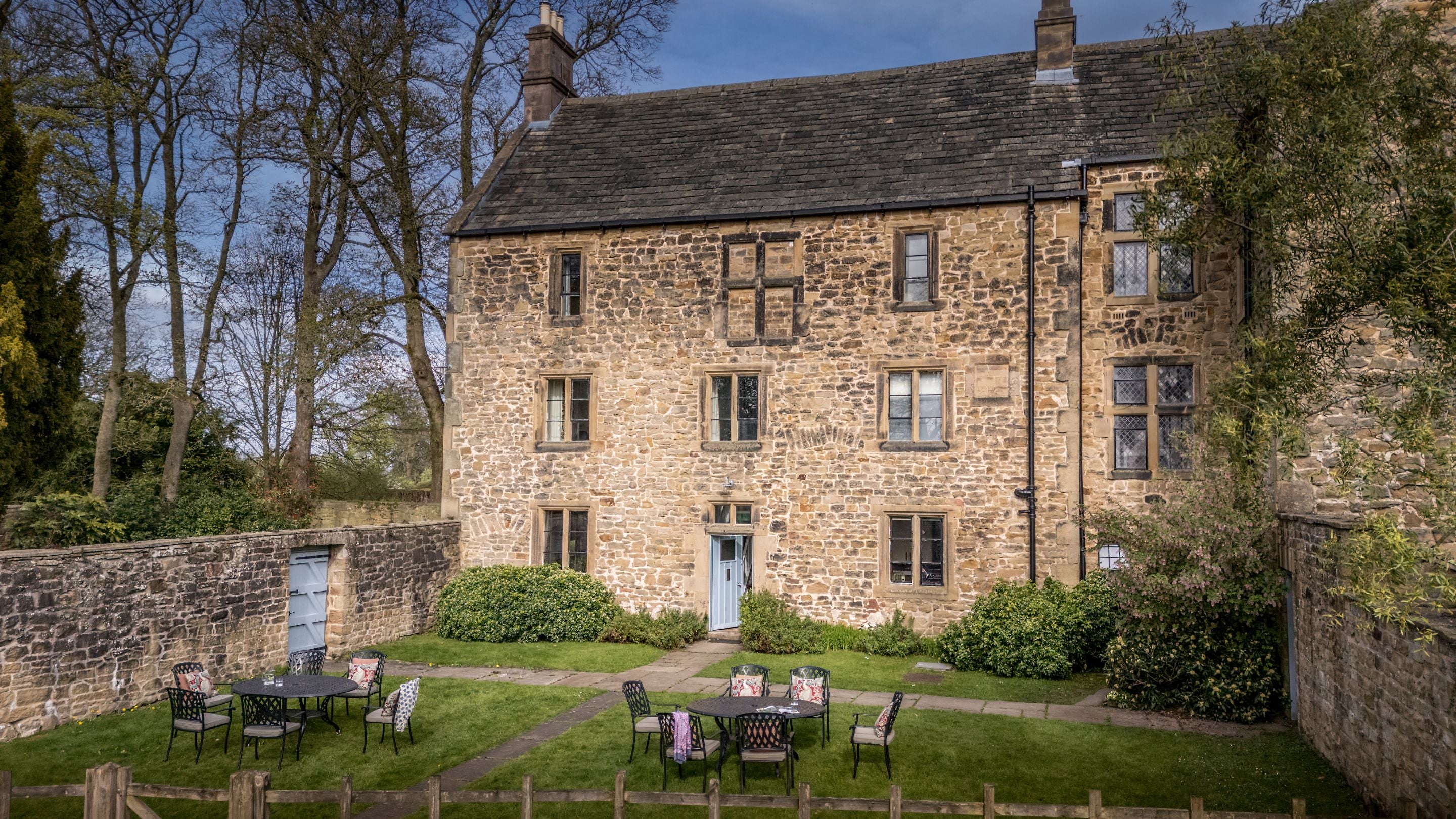 An aerial view of 6 High Hazels and its garden, with lawn and outdoor dining furniture, Derbyshire