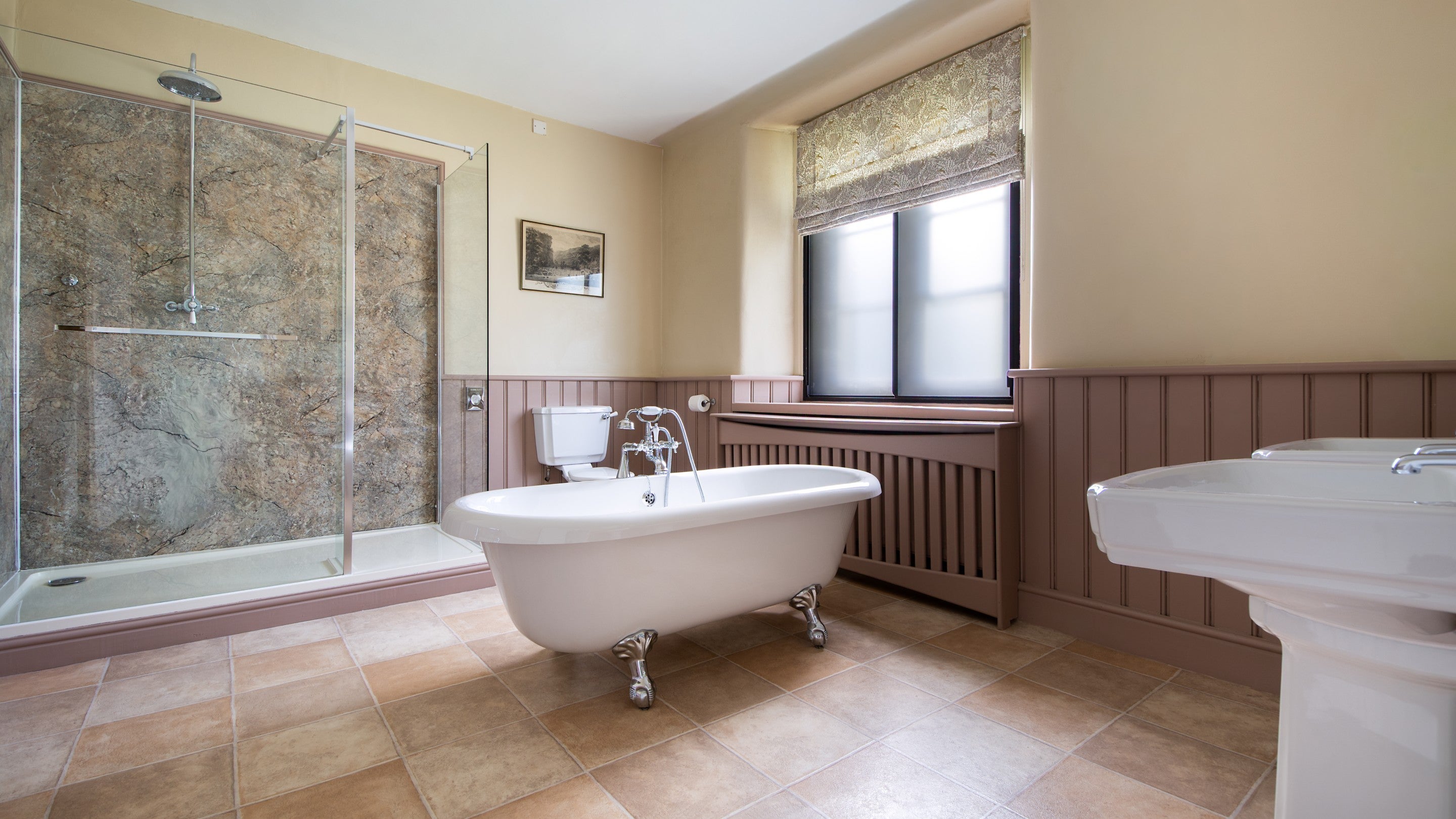 The bathroom with roll-top bath and freestanding shower at 6 High Hazels, Derbyshire