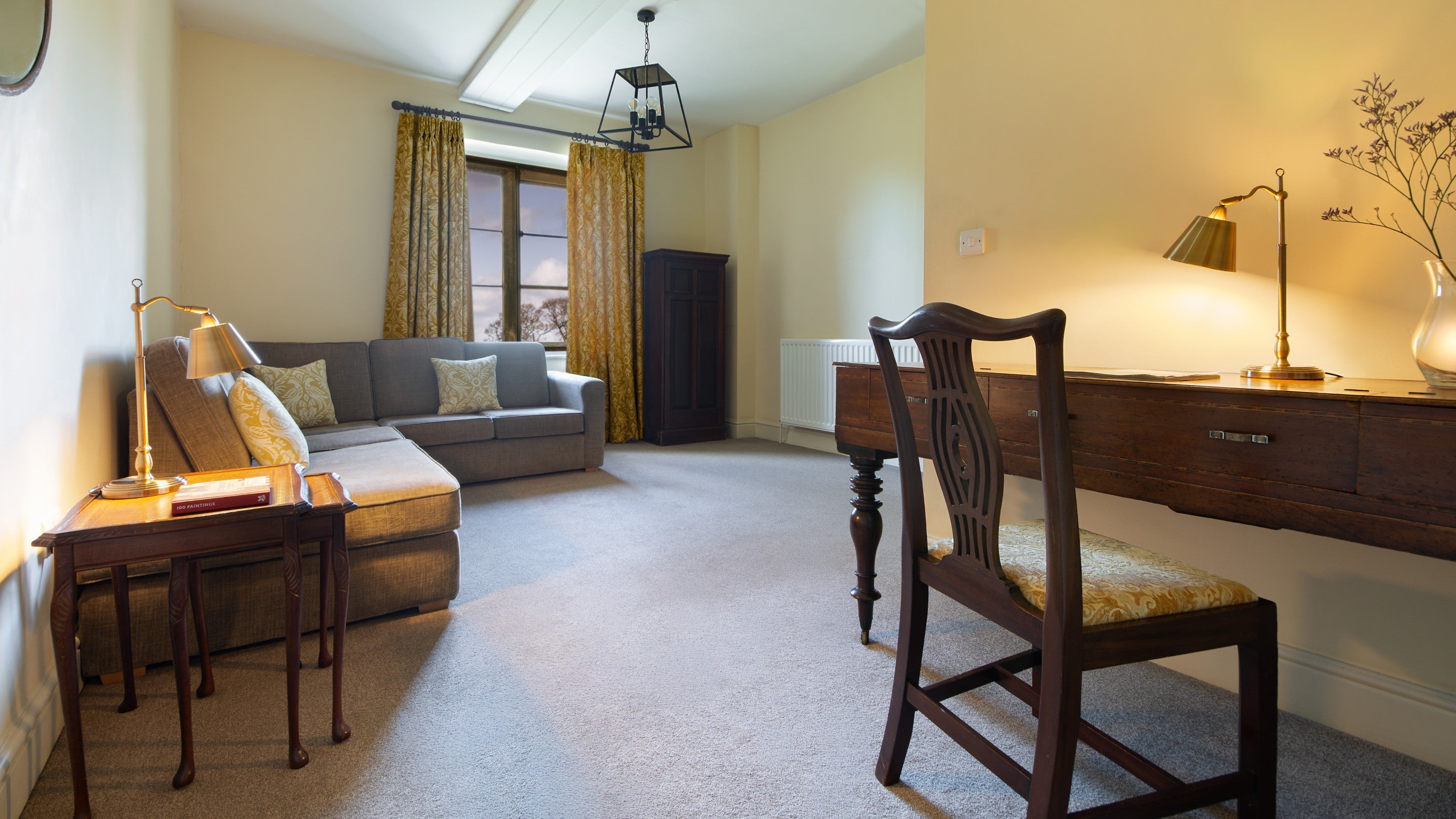 The second-floor landing with sofa, desk and chair, which leads to the hallway to three bedrooms at 6 High Hazels, Derbyshire