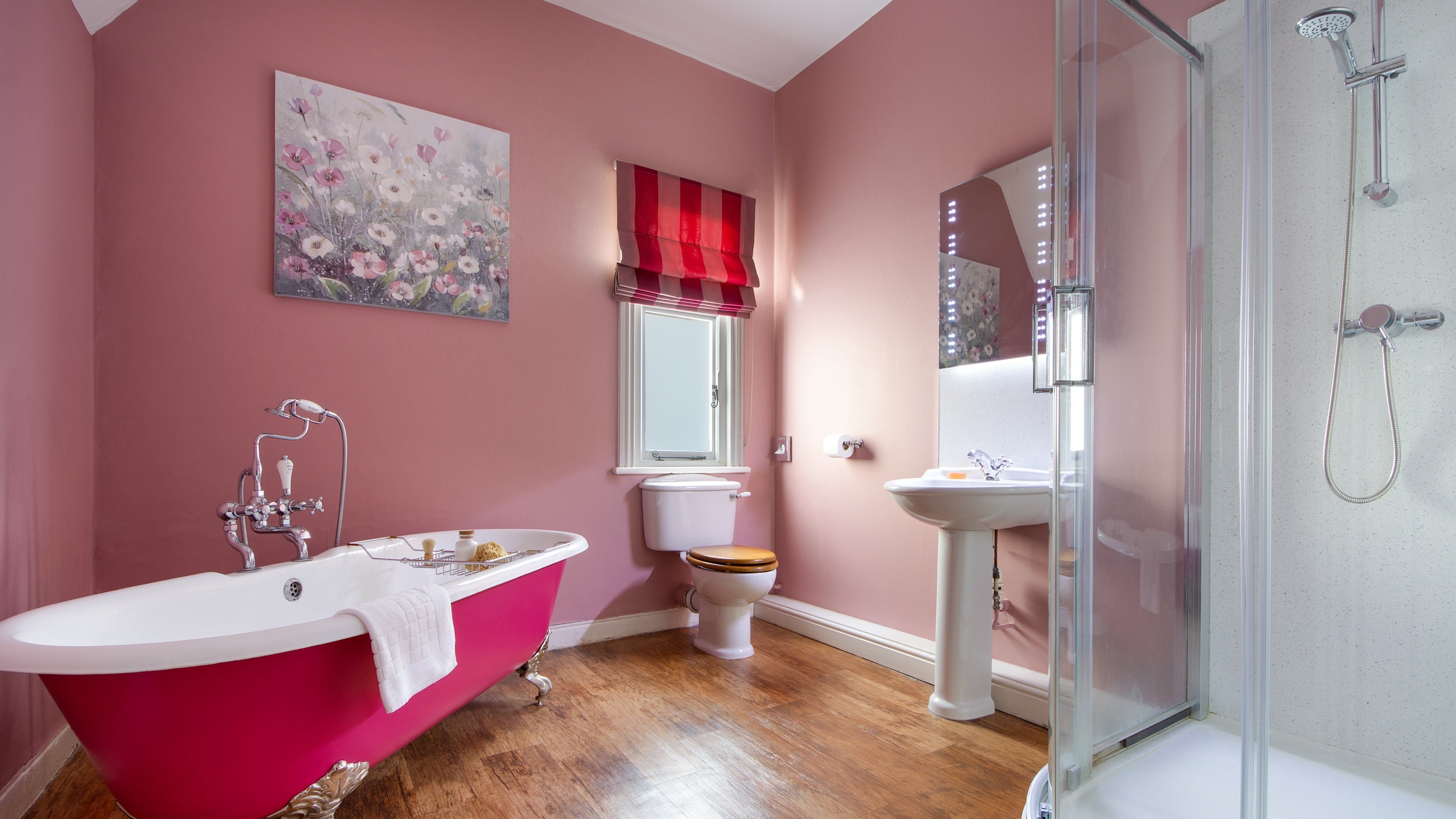 The bathroom with roll-top bath and freestanding shower at Kedleston Park House, Derbyshire