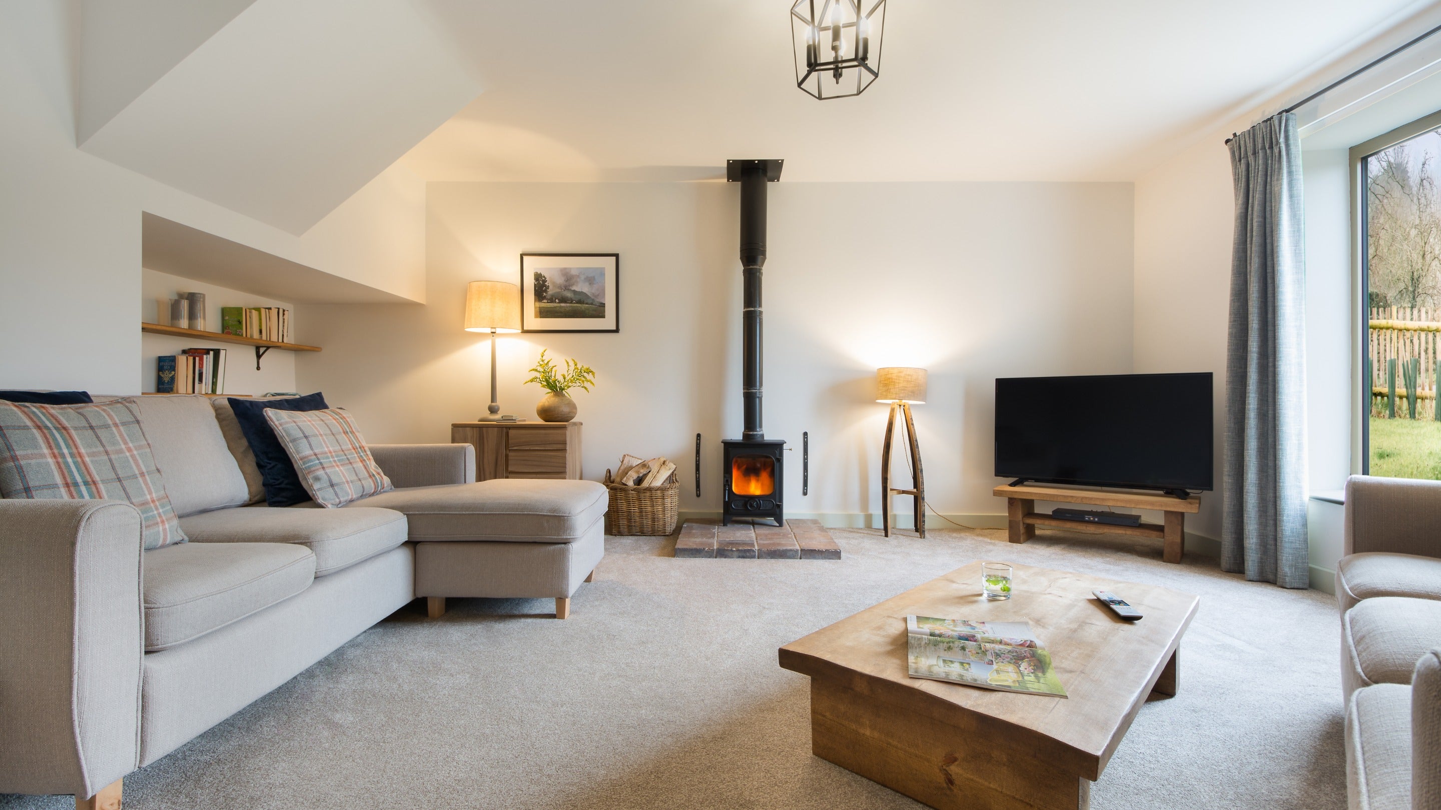 The sitting room with woodburner at 1 Morville Barn, Shropshire