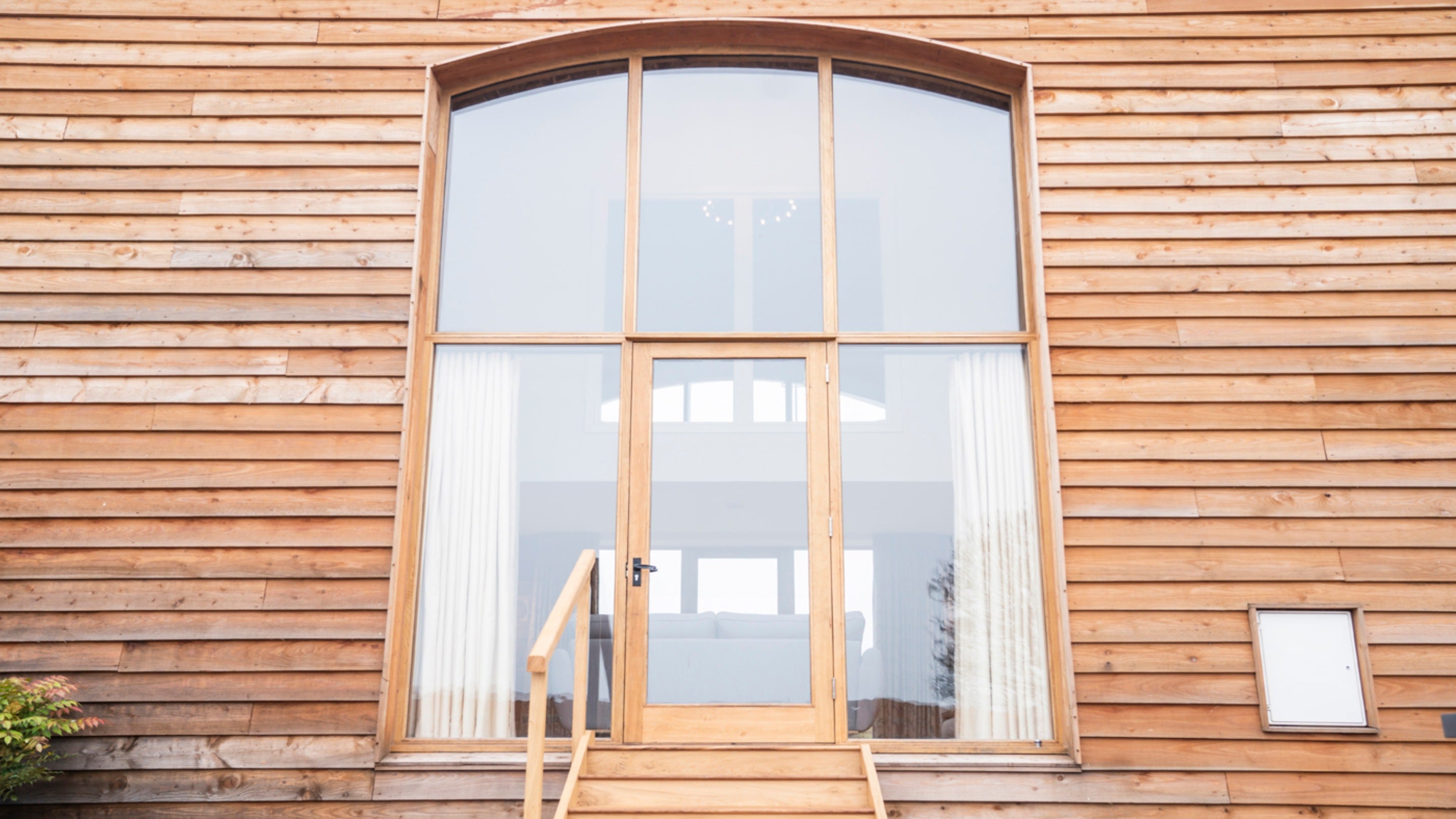 The double-height windows with door and steps down to the garden at Sandybury Barn, Shropshire