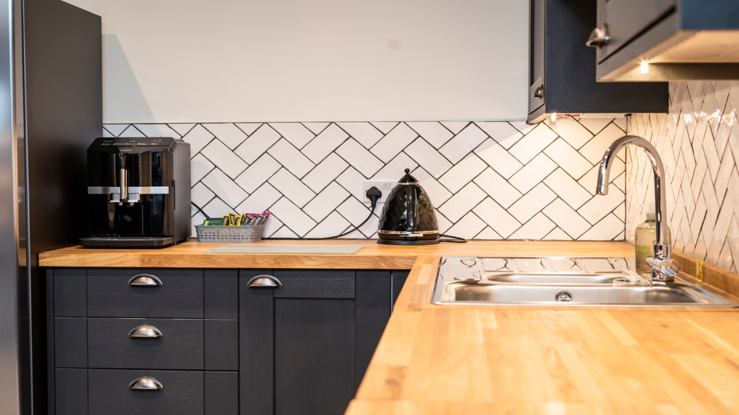 The kitchen at Sandybury Barn with the adjustable sink at the raised height, Shropshire