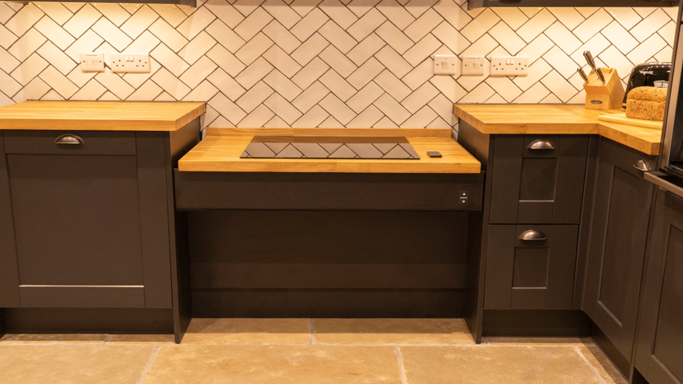 The adjustable hob in a lowered position in the kitchen of Sandybury Barn, Shropshire
