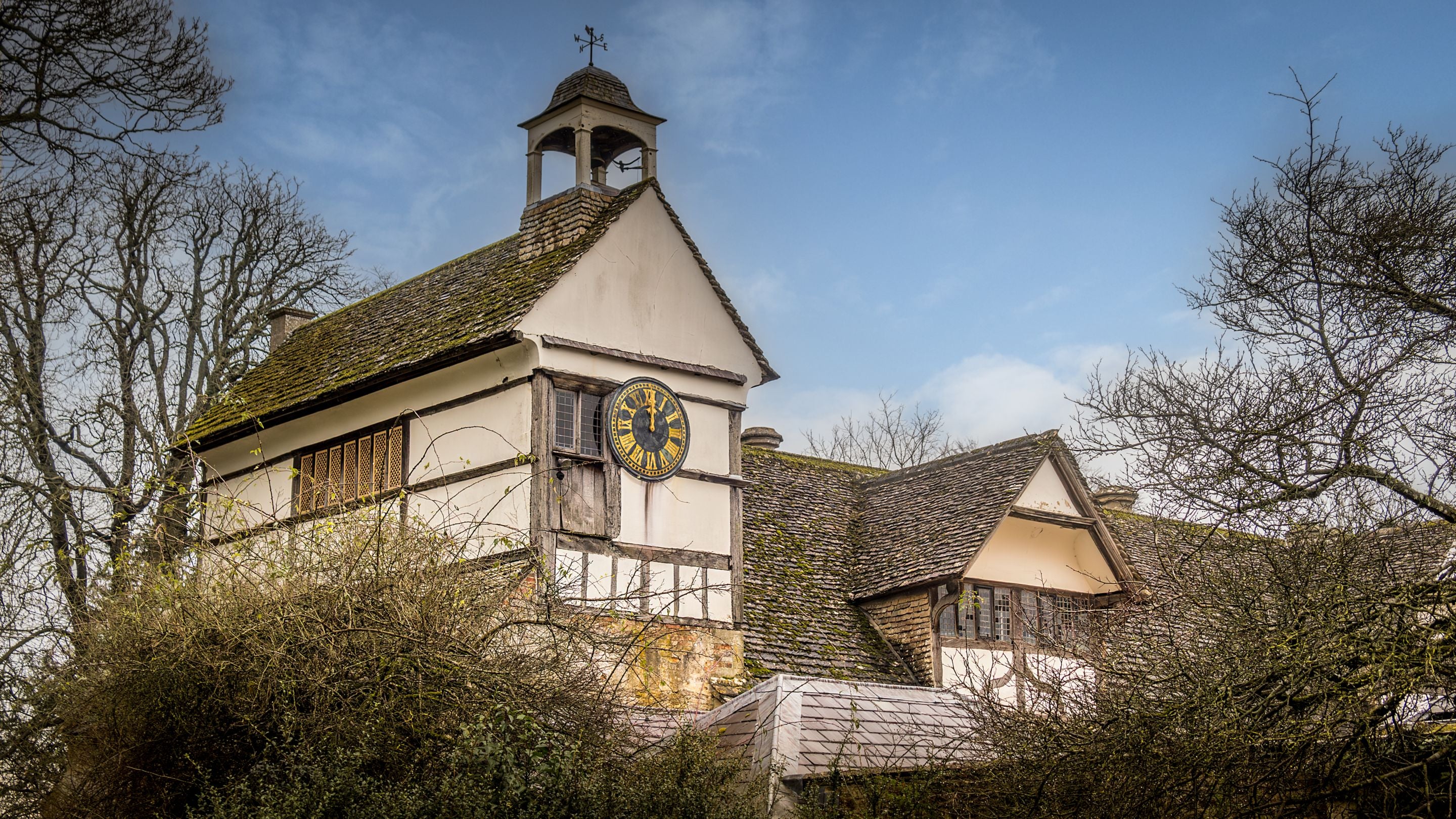 The clock tower in the Tudor Courtyard at Lacock Abbey in winter, Wiltshire