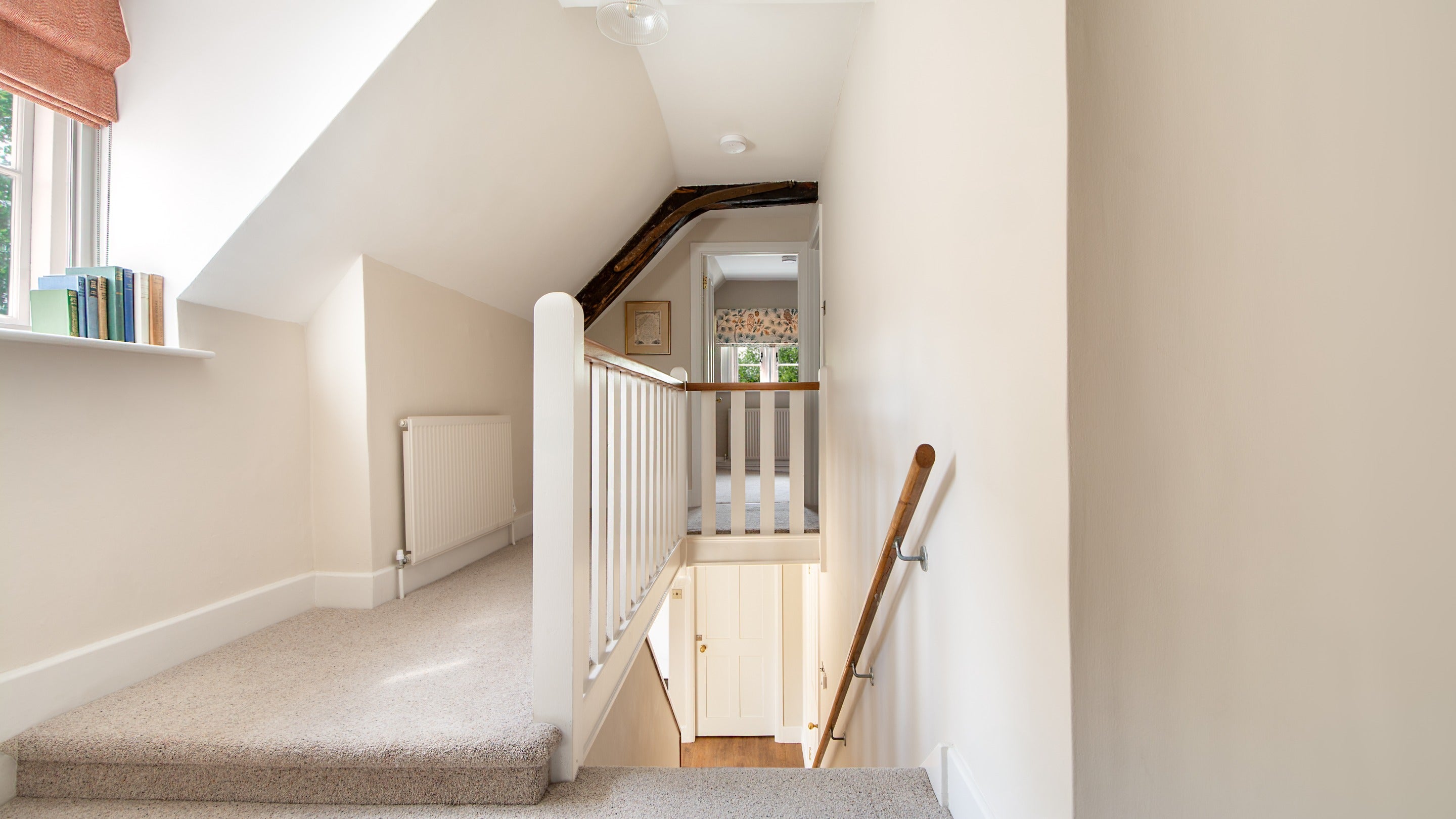 The landing with small step along the hall at 20 Church Street, Wiltshire