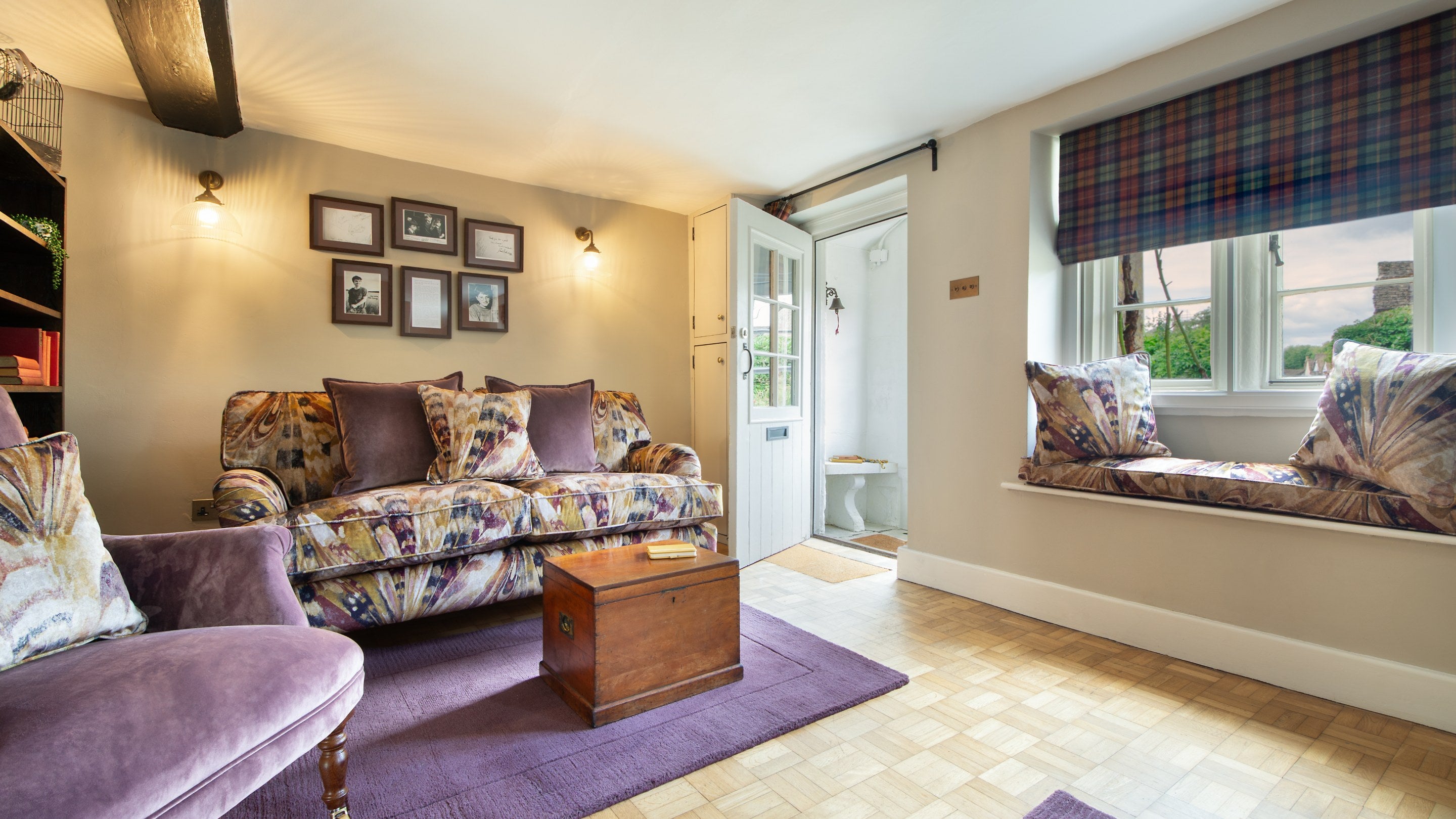 The sitting room with door into the porch at 20 Church Street, Wiltshire