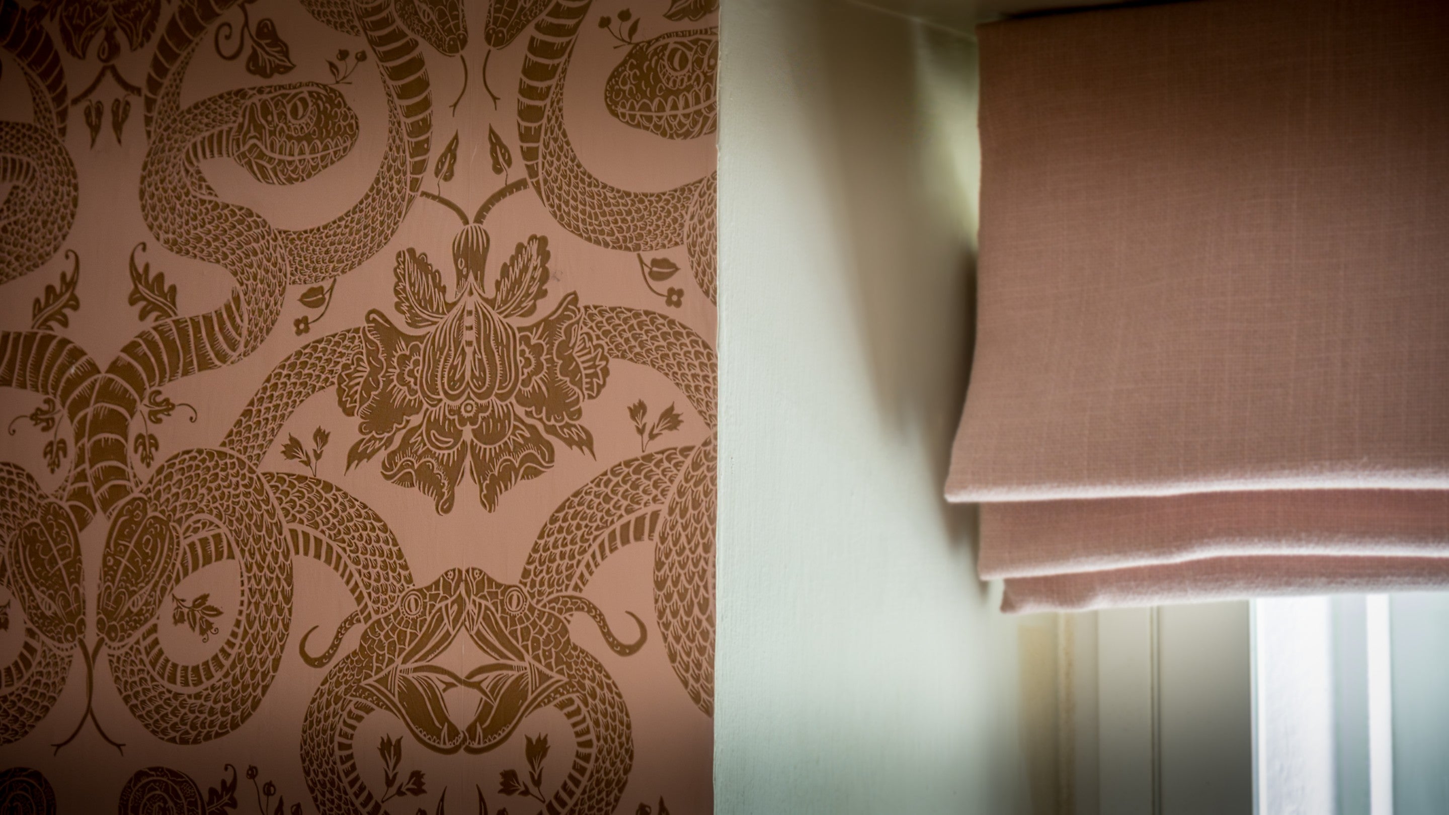The downstairs toilet with snake designs on the wallpaper at 20 Church Street, Wiltshire