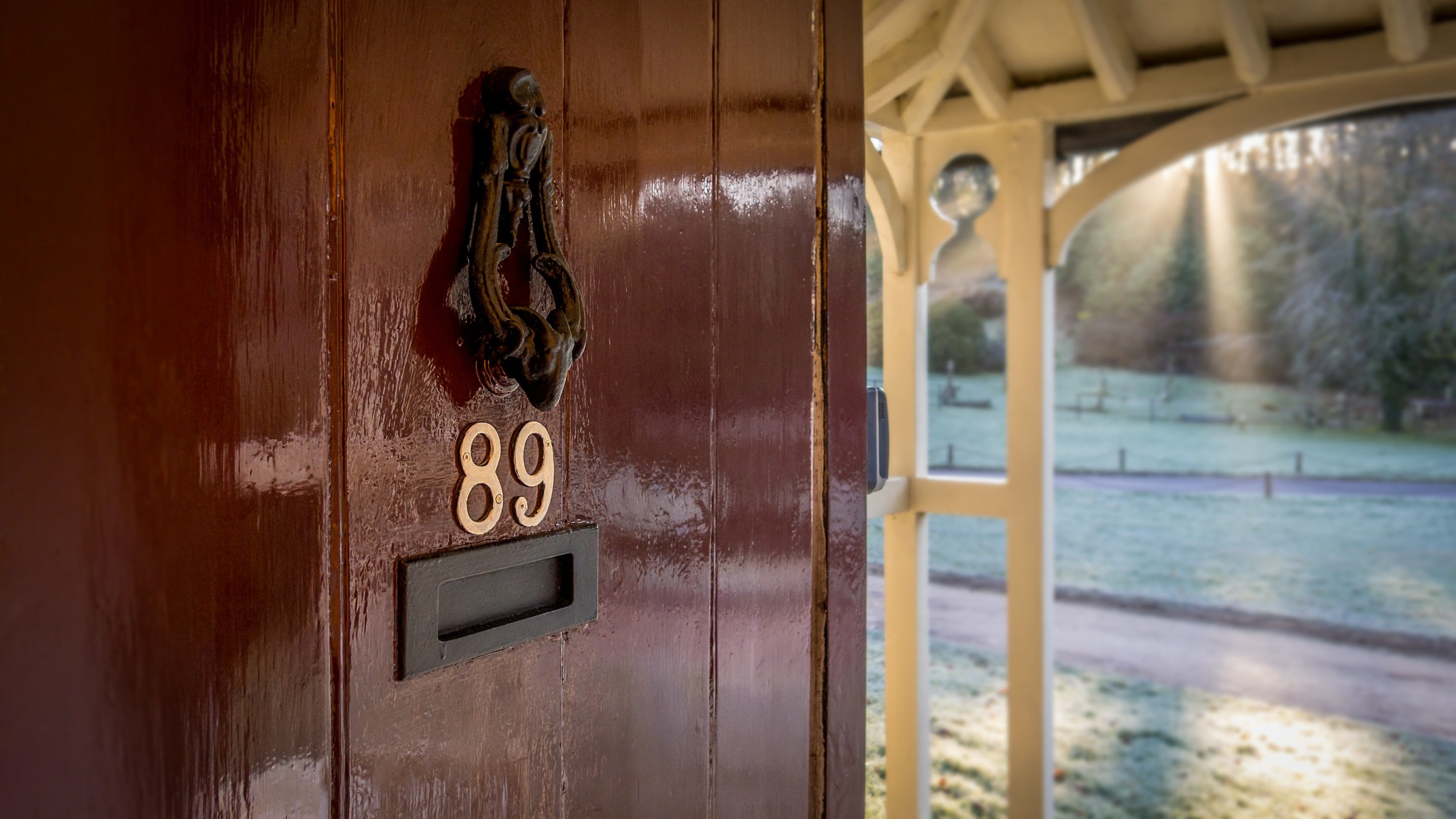 The front door at 89 Church Lawn, opened to show the cottages open porch, Wiltshire