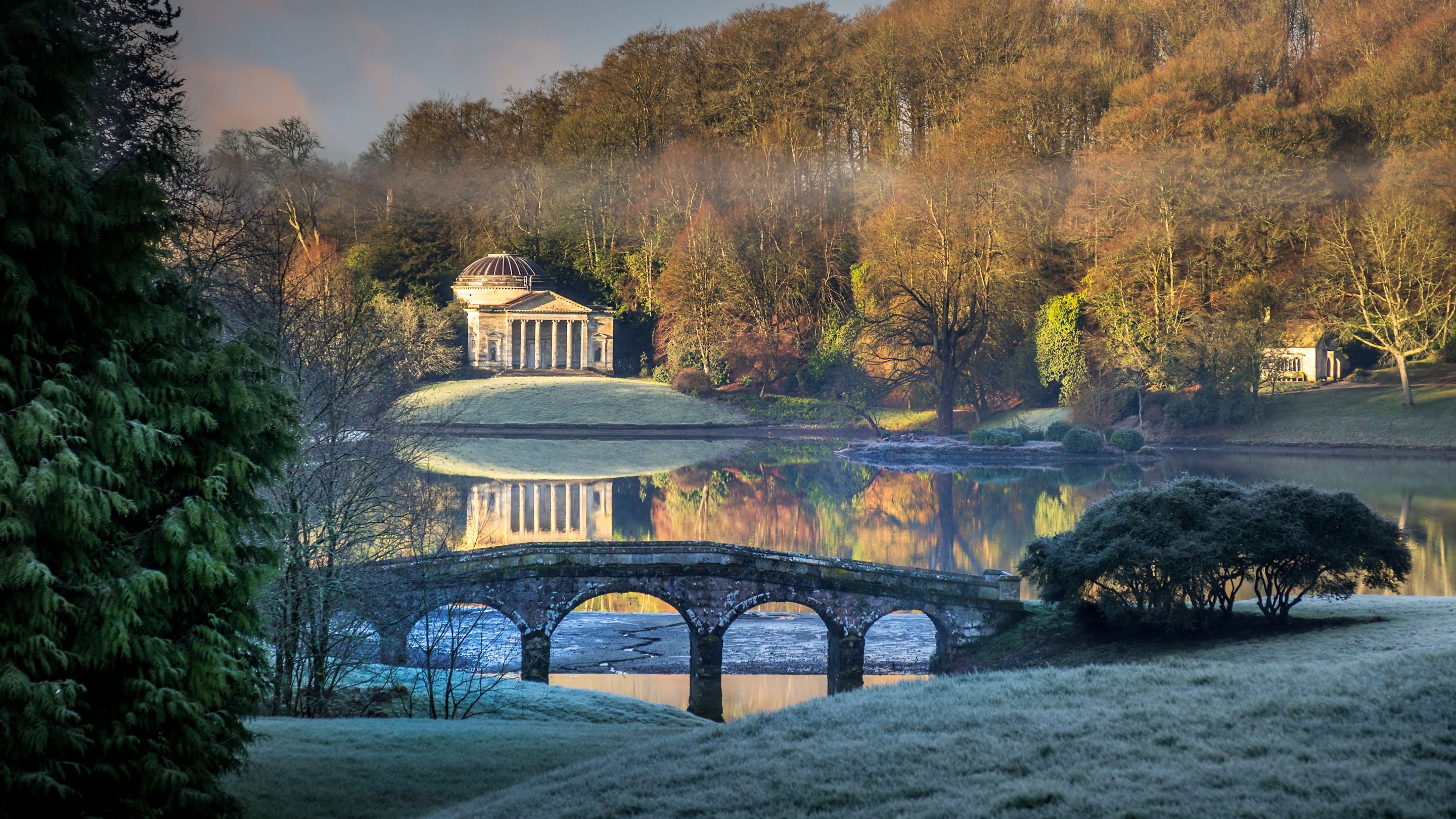 Stourhead's garden on a frosty winter morning, showing Wiltshire the lake, Palladian Bridge and Pantheon temple, Wiltshire