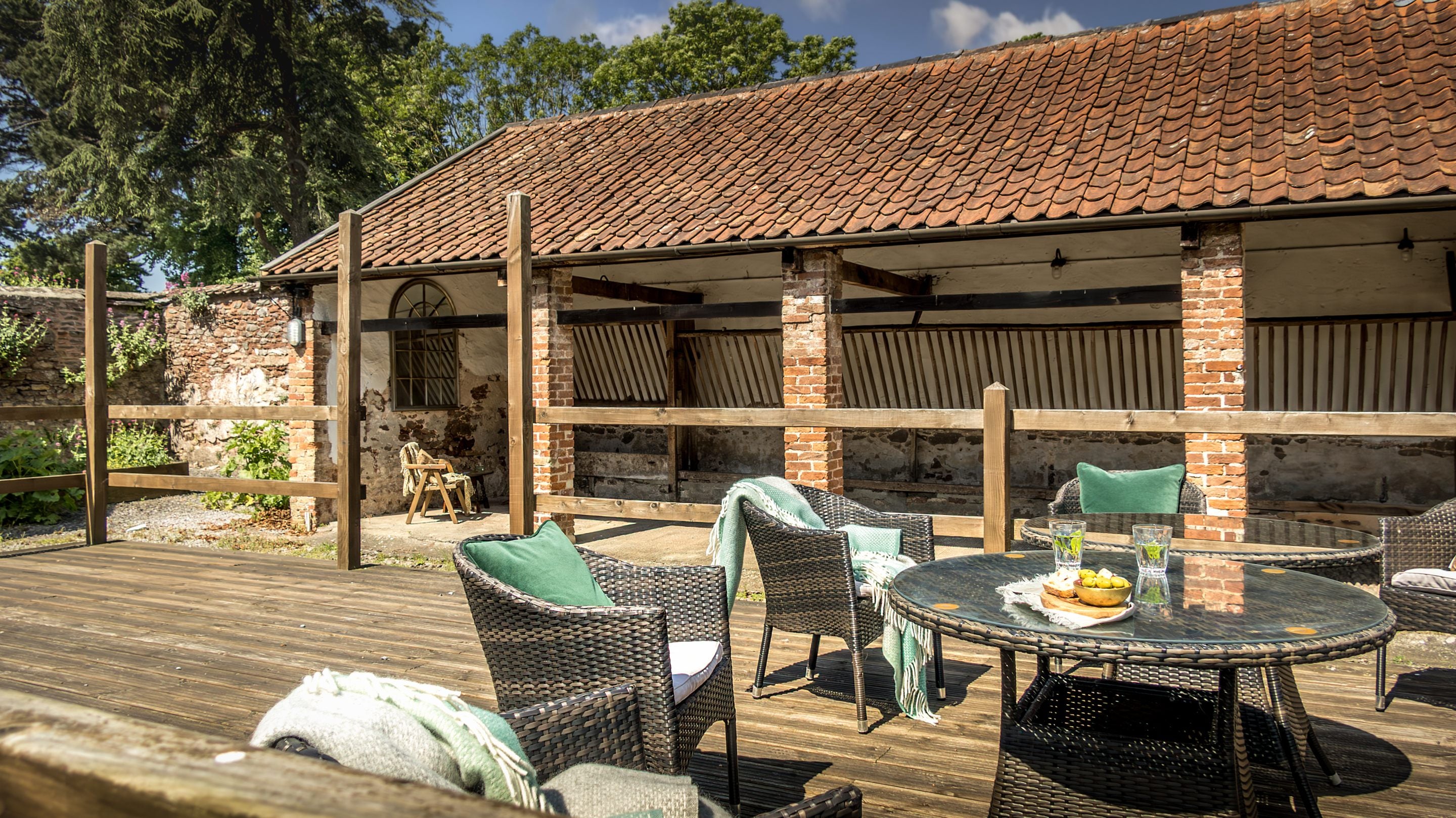 The decking area with outdoors tables and chairs at Cross Lane House, Somerset