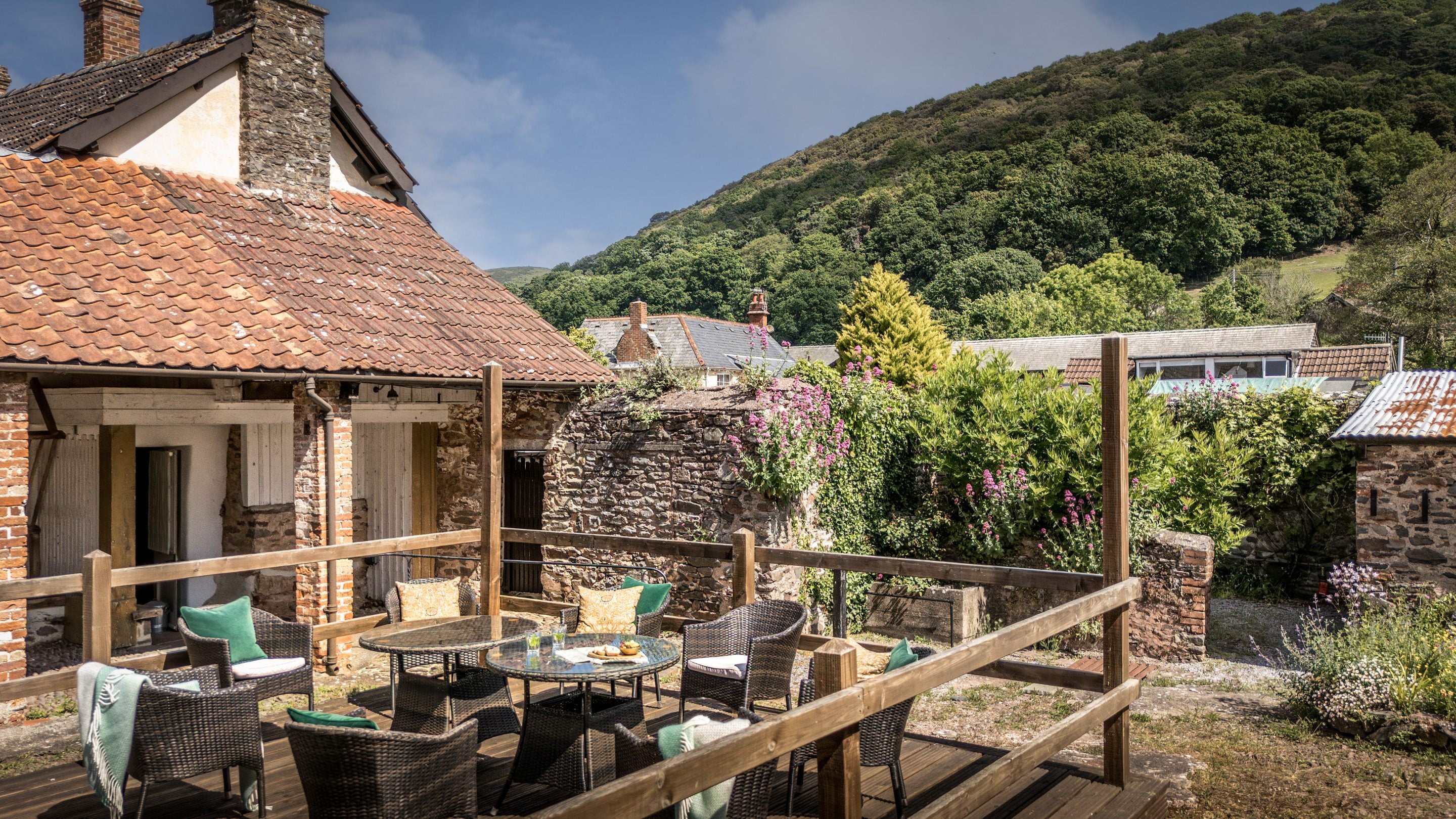 The raised deck with tables and chairs at Cross Lane House, Somerset