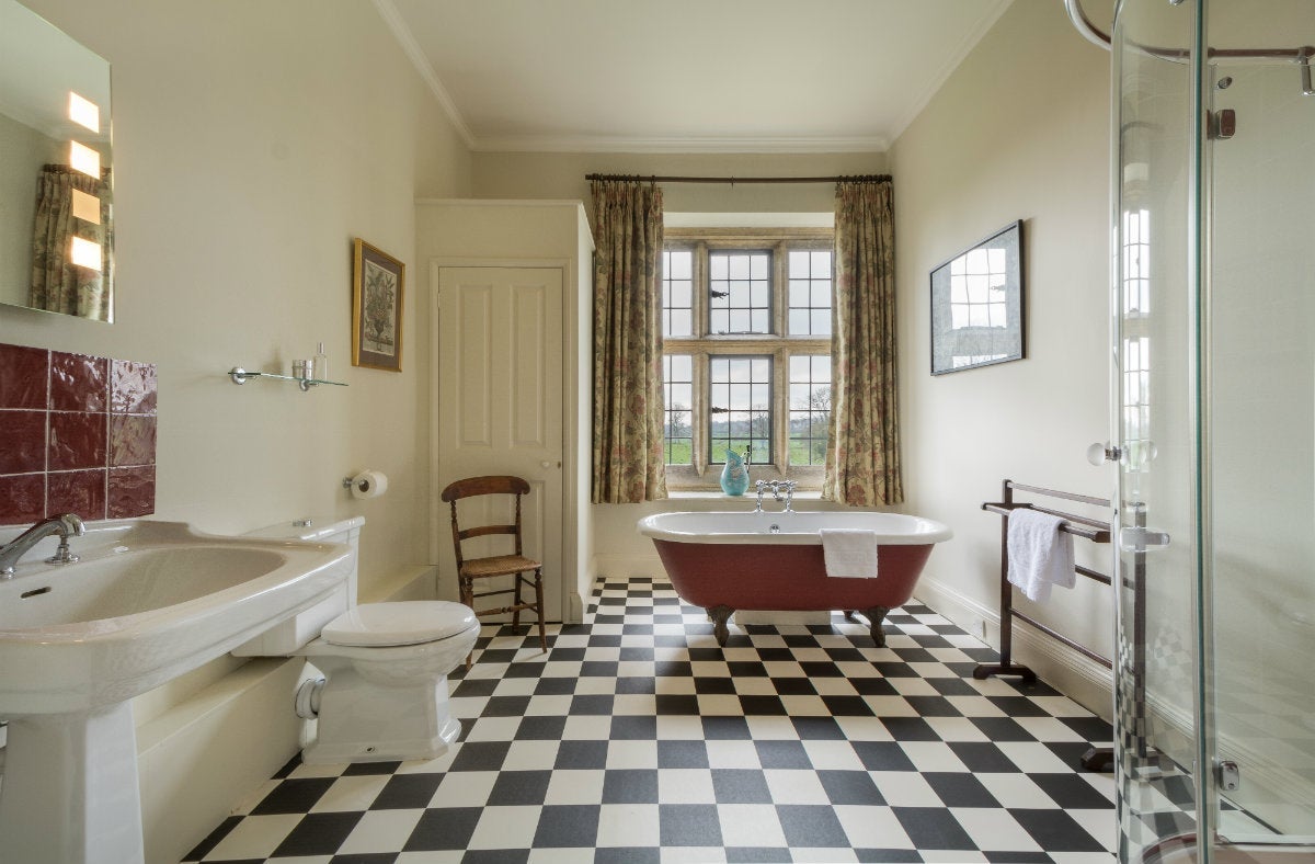 First-floor bathroom with roll-top bath and freestanding shower at Lytes Cary, Somerset
