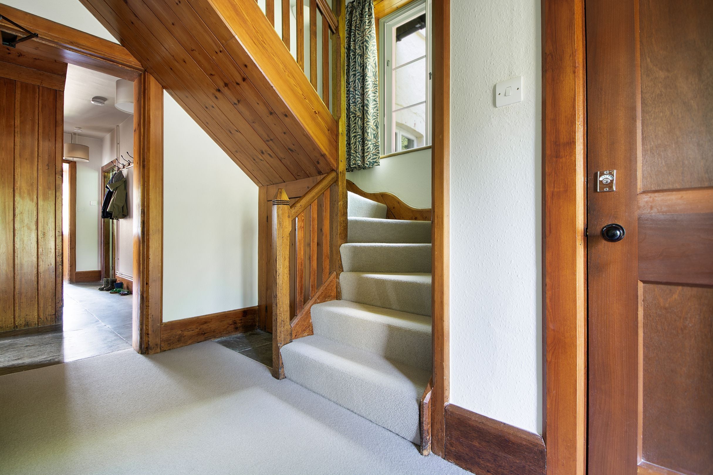 The downstairs hallway and stairs at Selworthy Farmhouse, Somerset