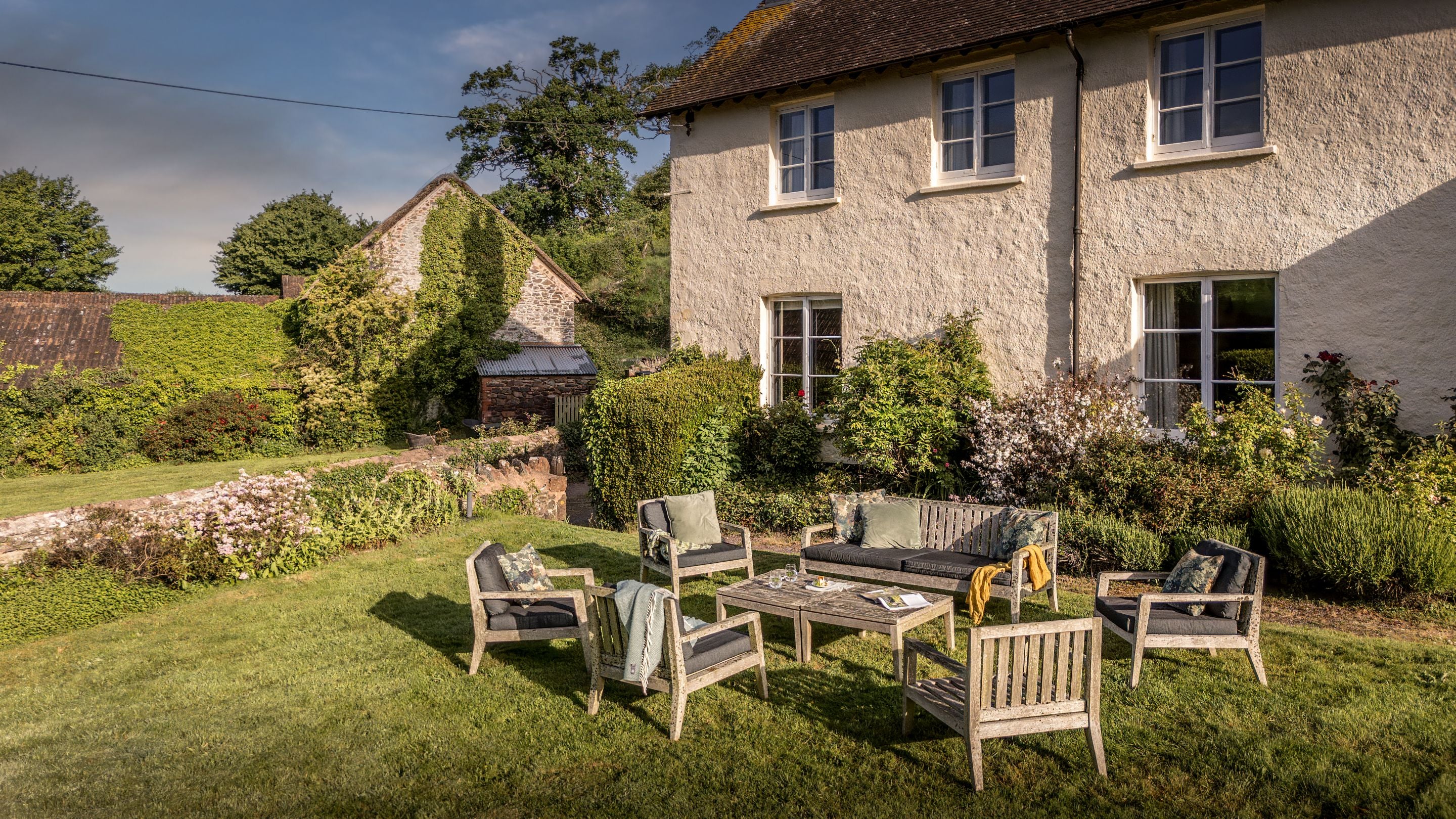 Table and chairs in the front garden at Selworthy Farmhouse, Somerset