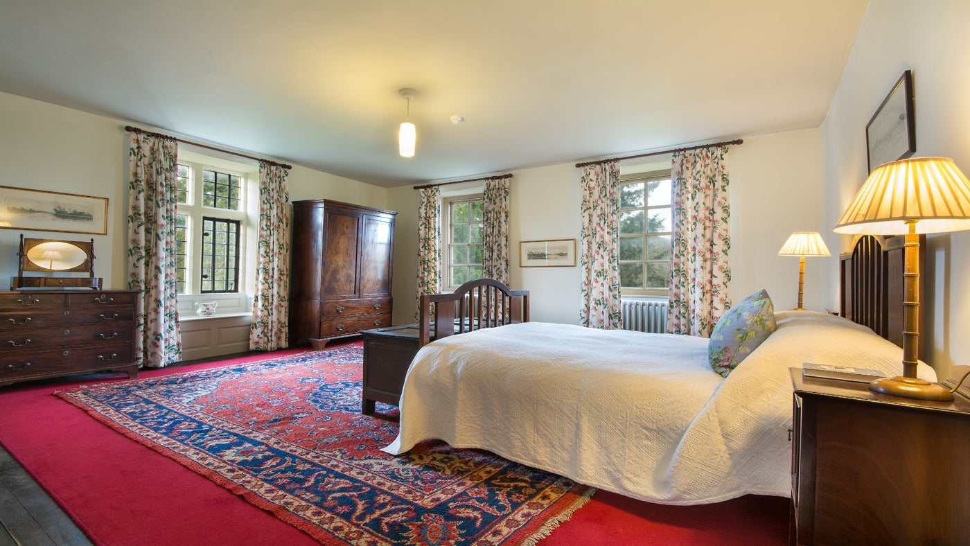 One of the light, airy double bedrooms at Tintinhull House, Yeovil, Somerset