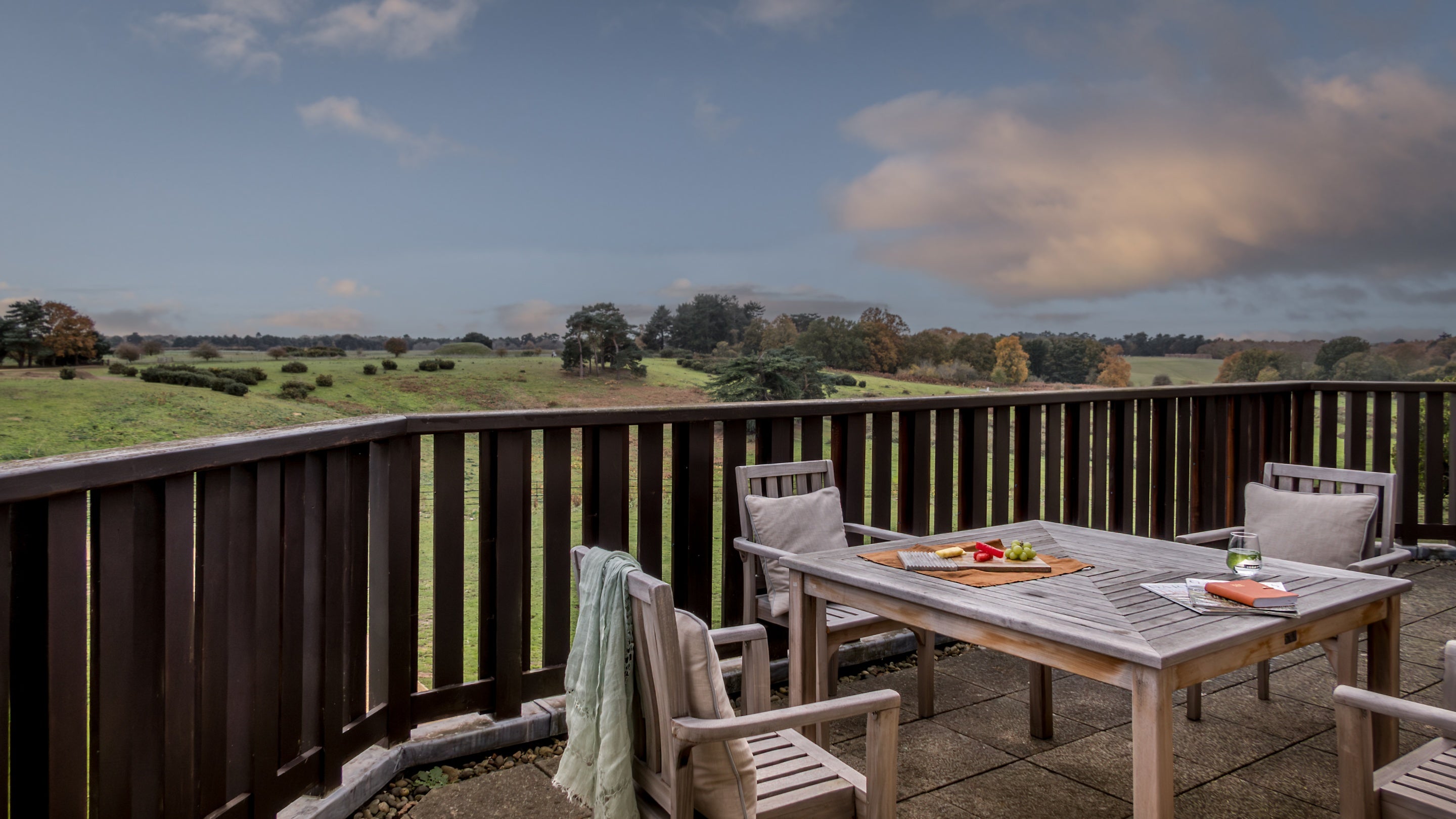 Deben View's balcony with outdoor dining furniture, with views of Sutton Hoo, Suffolk