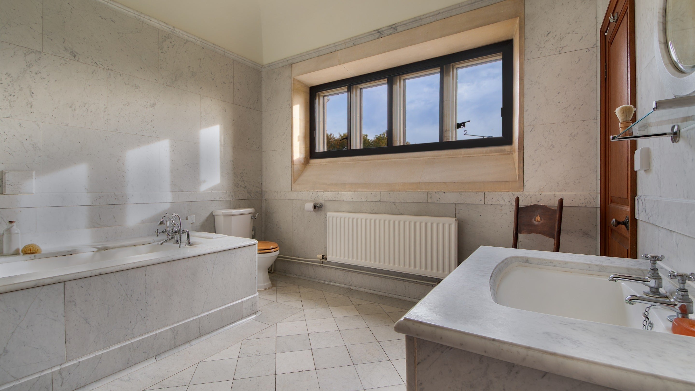 Edith Pretty’s original marble bathroom at Deben View, with bath with shower attachment, Suffolk