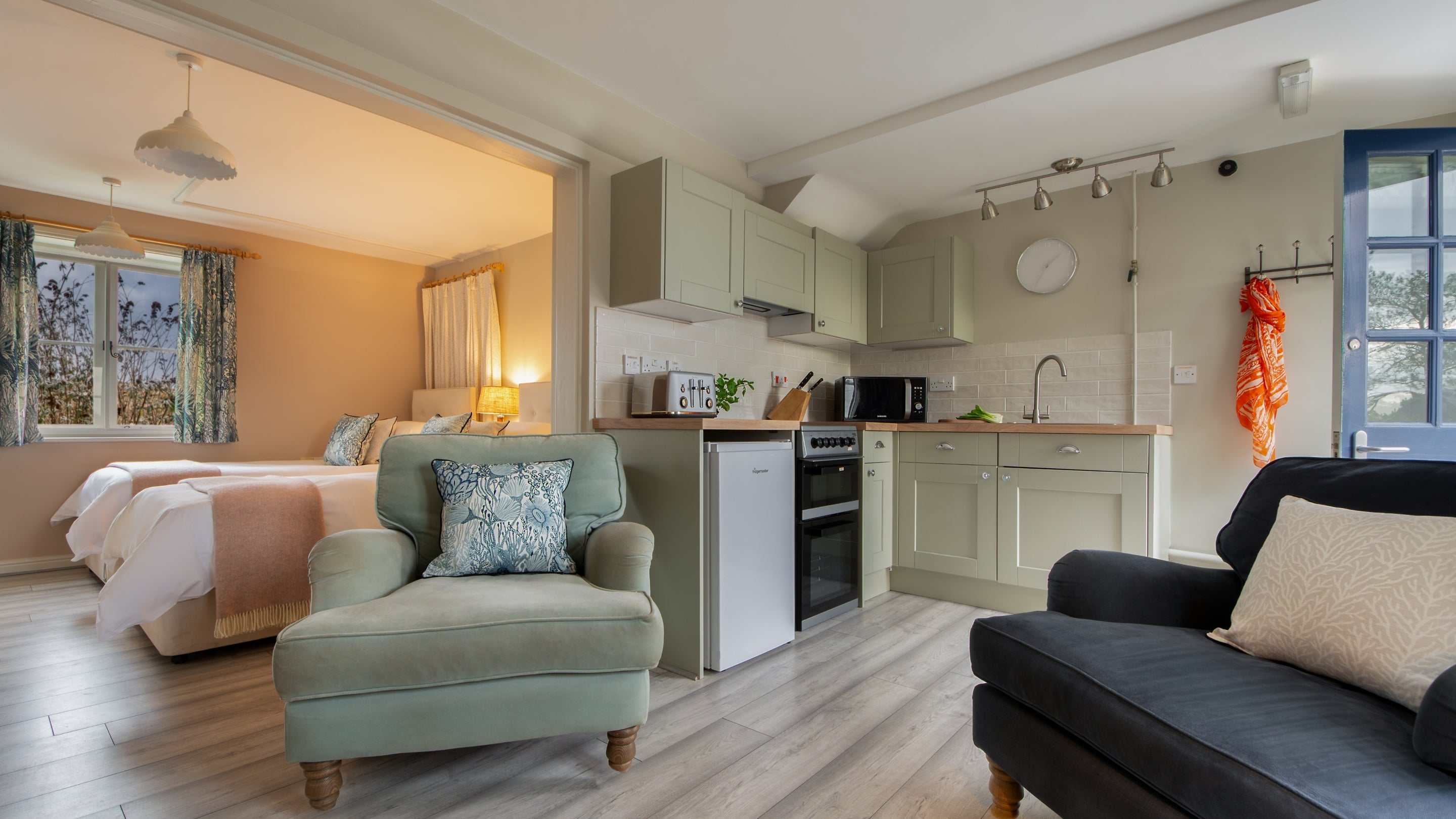 The open plan bedroom, kitchen and seating area at Nightjar, Suffolk